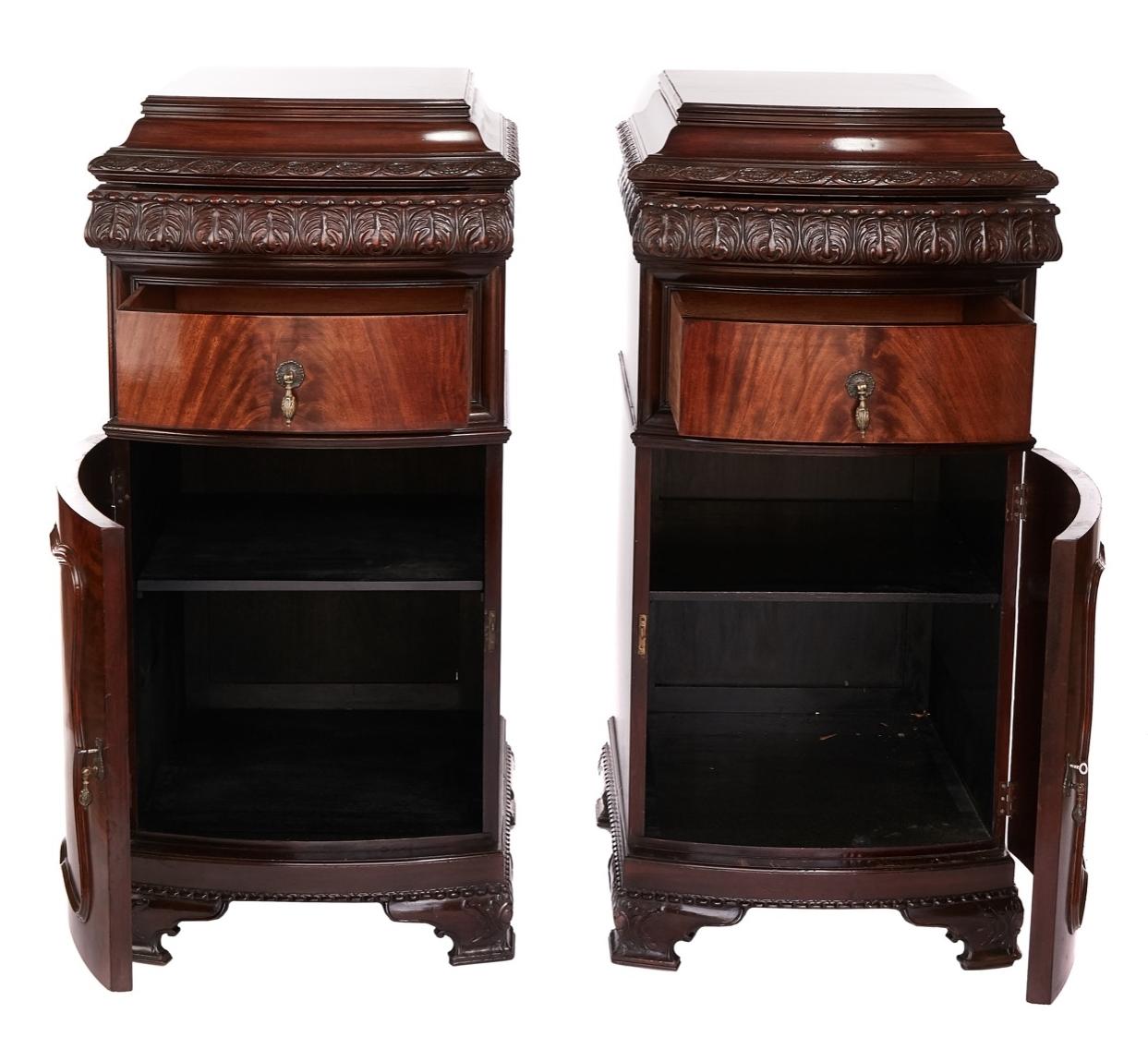 Pair Large Mahogany carved Bowfront Pedestal Cupboards, circa 1920s
Shaped tops with carving around, 
Each with single bowfront Drawer, 
bowfront cupboard beneath, open to reveal single shelf interior, 
working keys. 
sitting on carved ogee shape