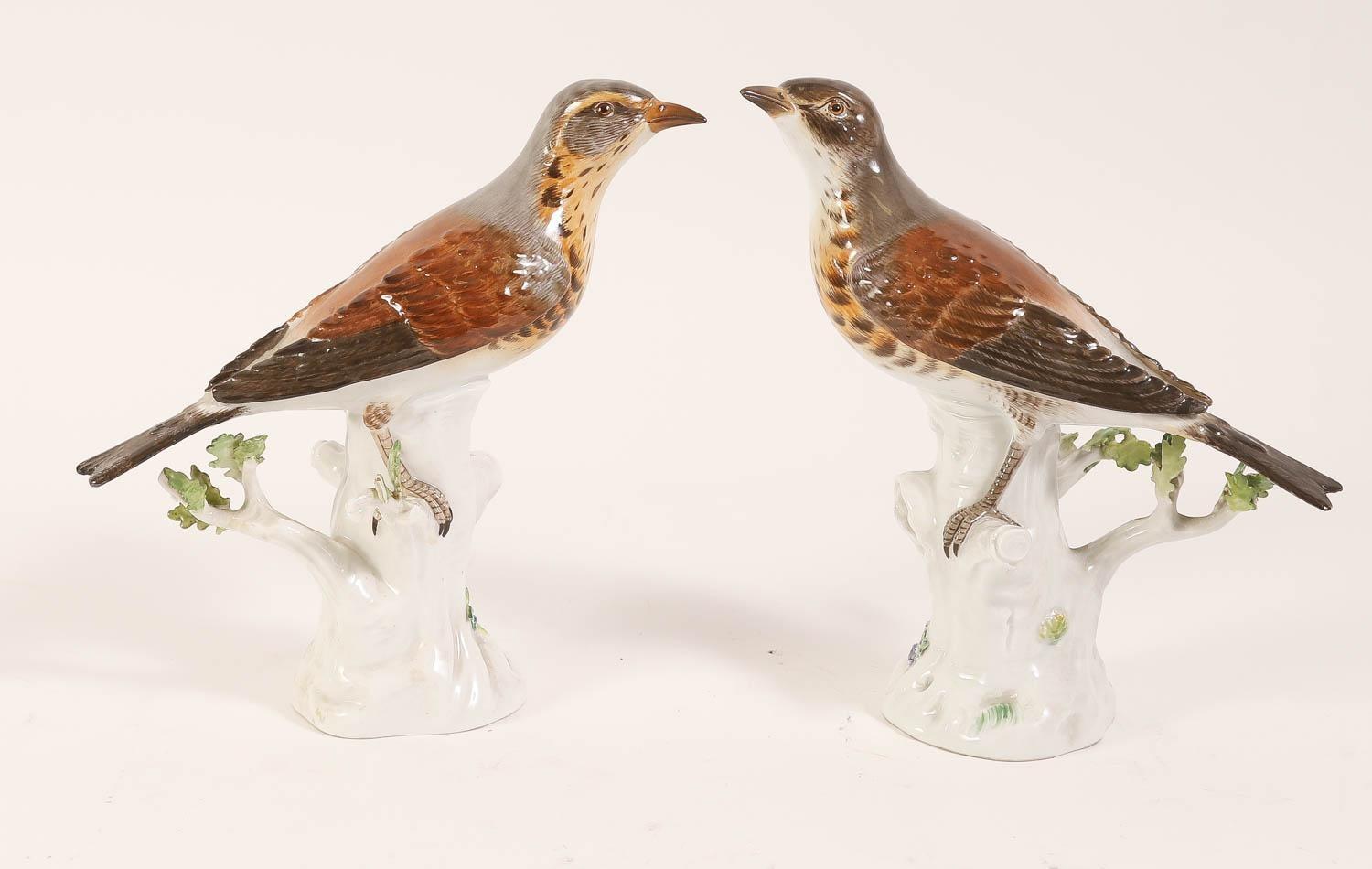 Pair of antique (late 19th to early 20th century) Meissen glazed porcelain figurines depicting thrush birds perched on tree stumps.  Each with the blue crossed swords mark.  Undersides incised No. 113 and impressed 147 and 151 respectively.  Heights