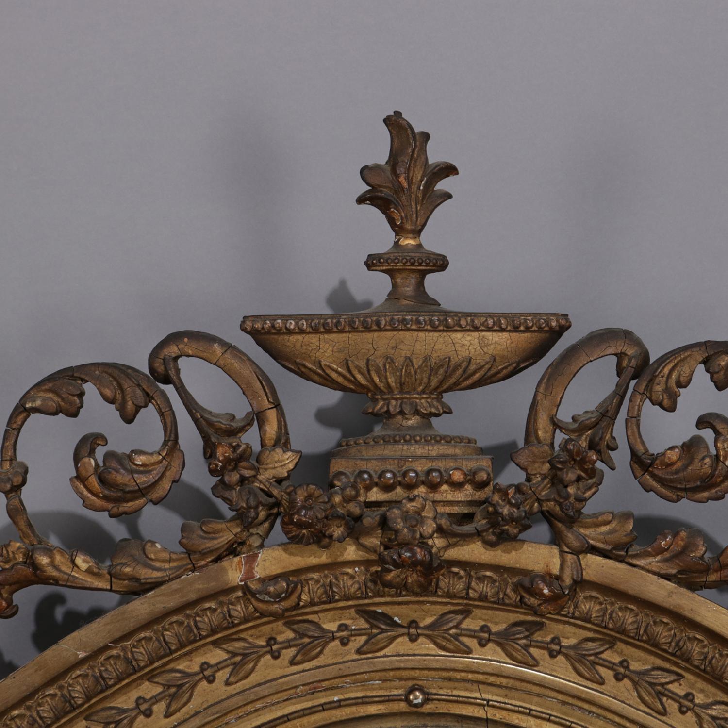 Pair of antique neoclassical wall sconces feature pierced foliate frames with urn from finial and three candle arms surrounding beveled mirrors, 19th century

Measures: 40