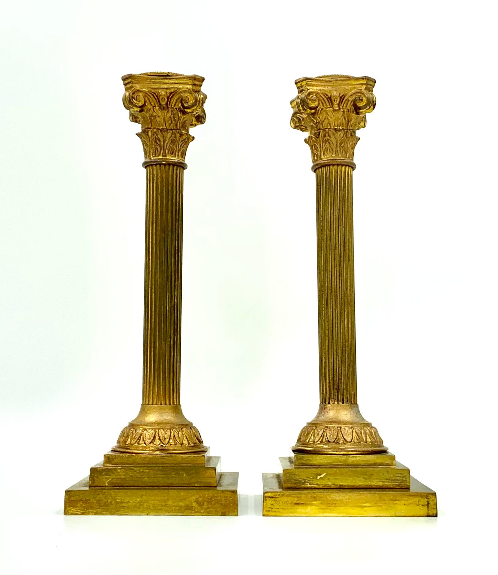 Pair Neoclassical style Corinthian column form gilt bronze candle holders
Late 19th- Early 20th Century
Attractive, well detailed Corinthian column capitals with reeded column bodies, circular acanthus leaf bases atop stepped square plinths.
Height: