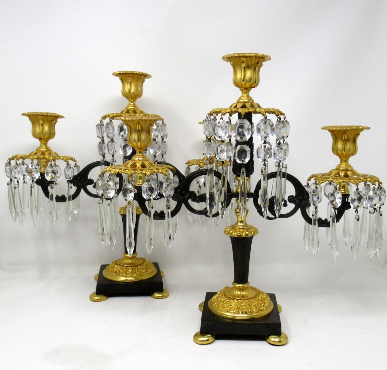 Stunning pair of French Louis XV style patinated bronze doré and ormolu three light candelabra, after a model by Pierre Gouthiere (1732-1813), mid-19th century

Each with a centered empire style bronze reeded support, issuing two decorative