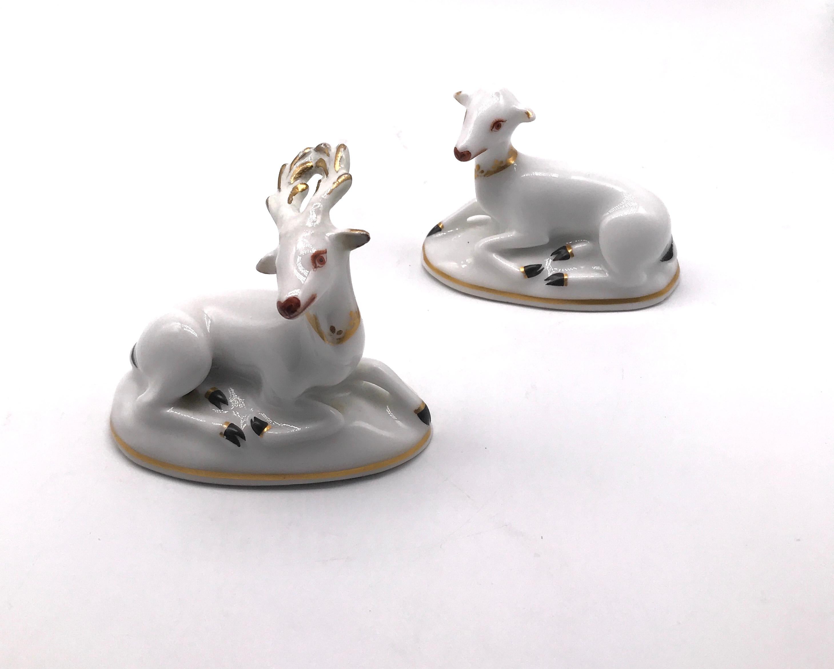 Though deer were frequently shown in porcelain, this is a rare pair of toy deer that were meant to be together and were kept together, in perfect condition, circa 1820. The pair includes a doe and stag in white and gilt, lying on an oval base,