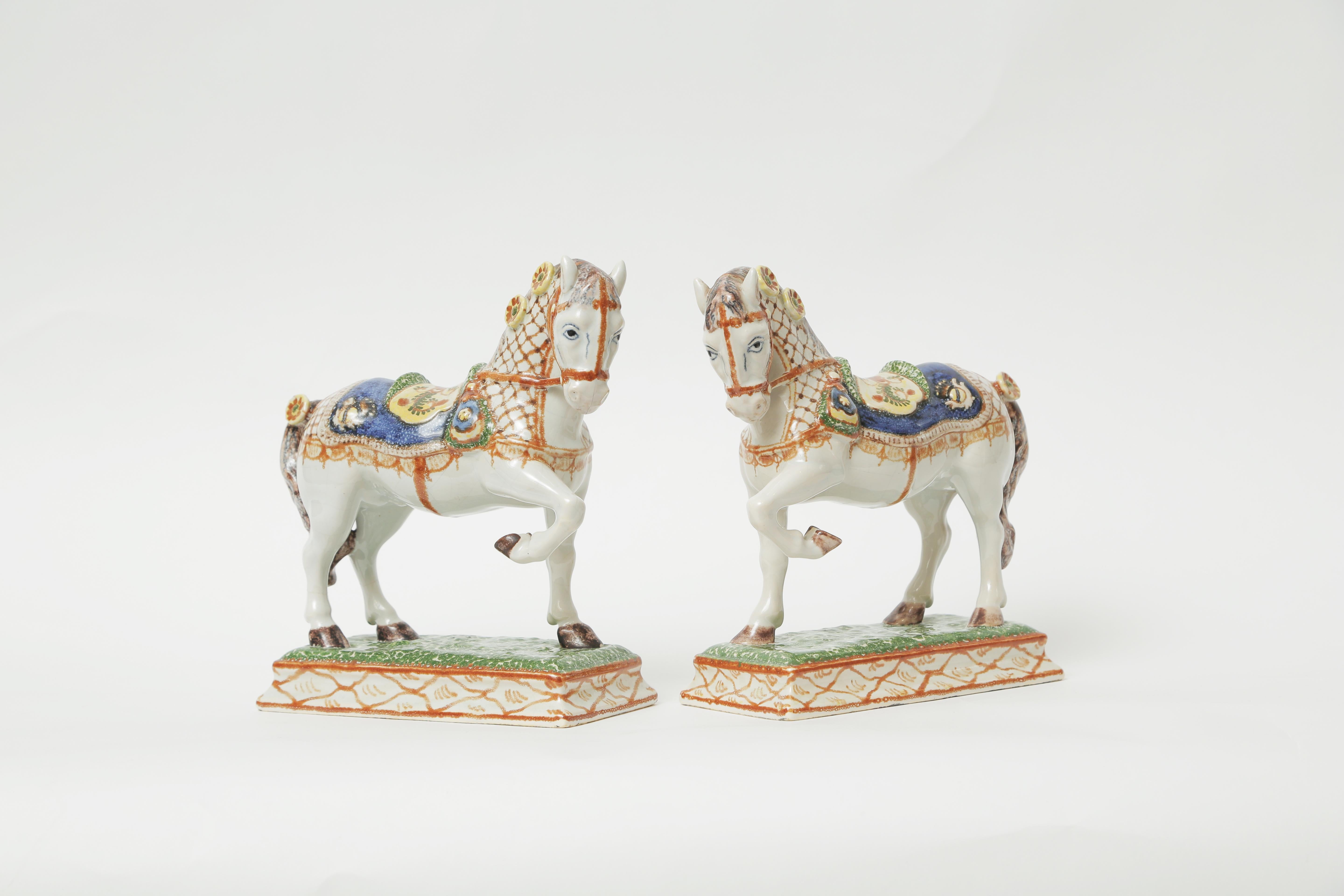 A fine and rare pair of 19th century French hand painted soft paste porcelain Ardennais horses. A well decorated opposing pair of horse sculptures on colorful decorated plinths. The Ardennais or Ardennes is one of the oldest breeds of draft horse,
