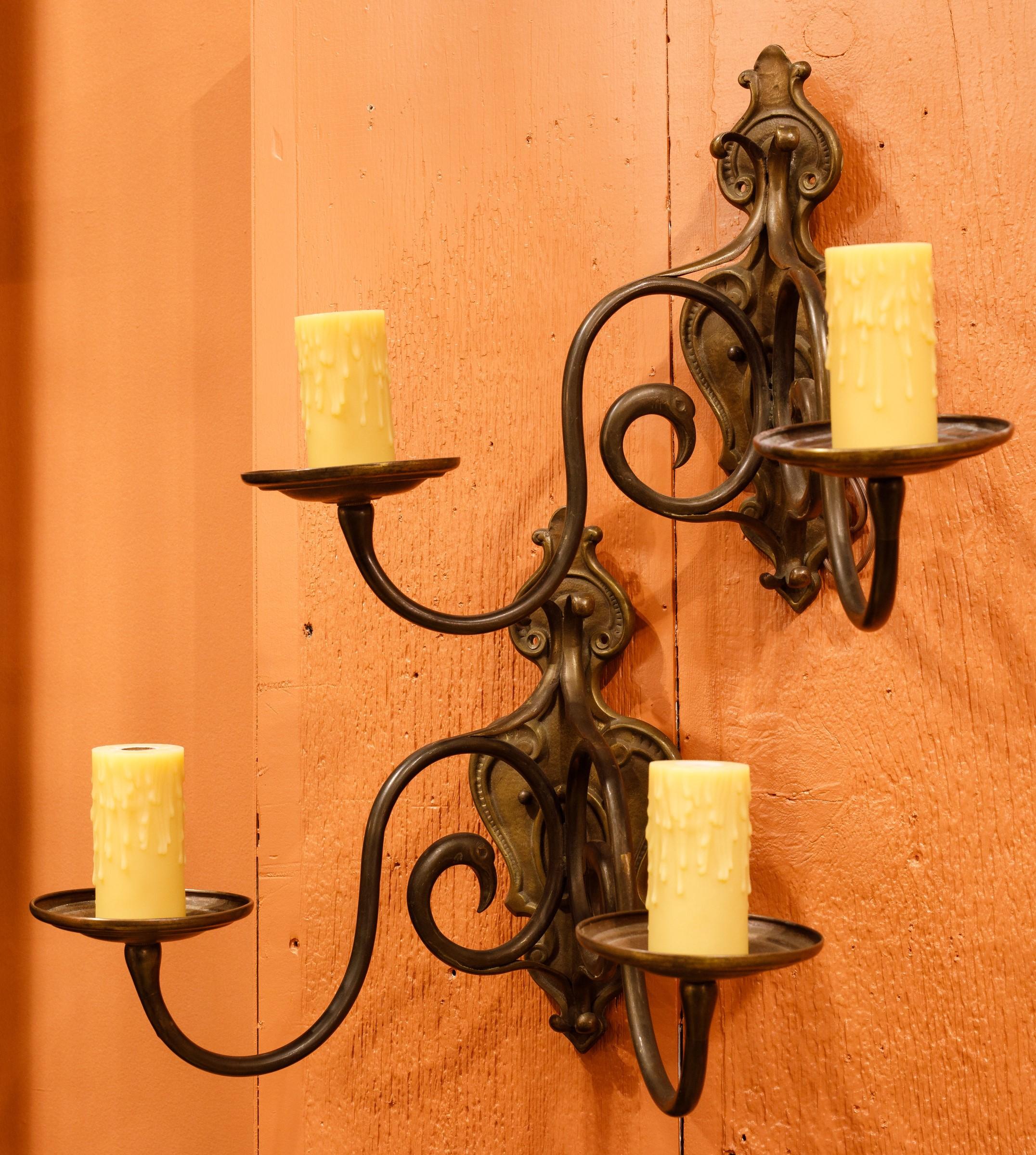 This pair of sconces is a beautiful classic and timeless pair of sconces.  They were purchased in Belgium but could be Belgian, French or Dutch.  The bronze sconces of have deep castings and unusual design.  They have hints of Arts and Crafts and