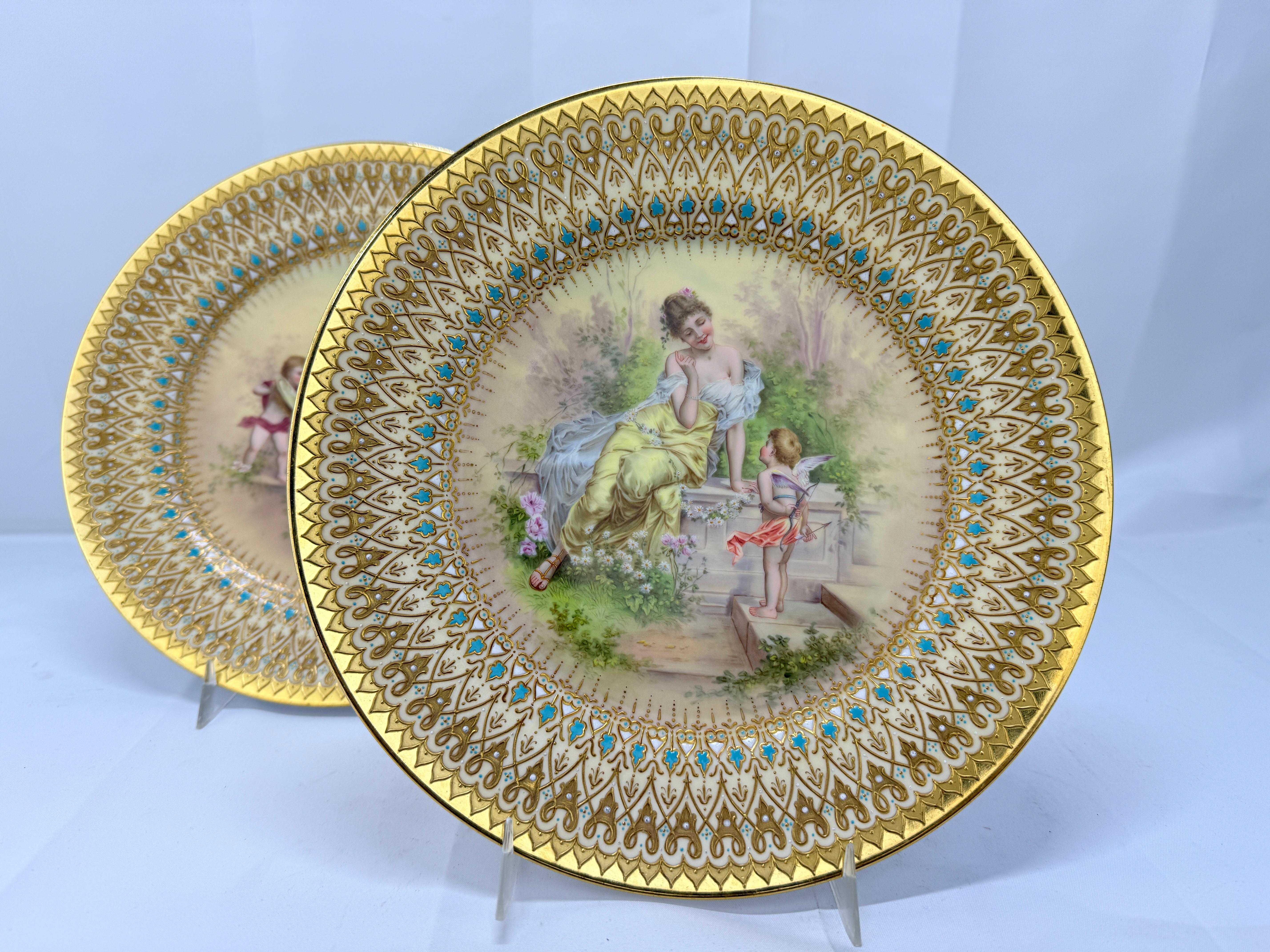 This exquisite pair of antique Royal Vienna porcelain plates, measuring 9.5 inches in diameter, beautifully illustrates the 