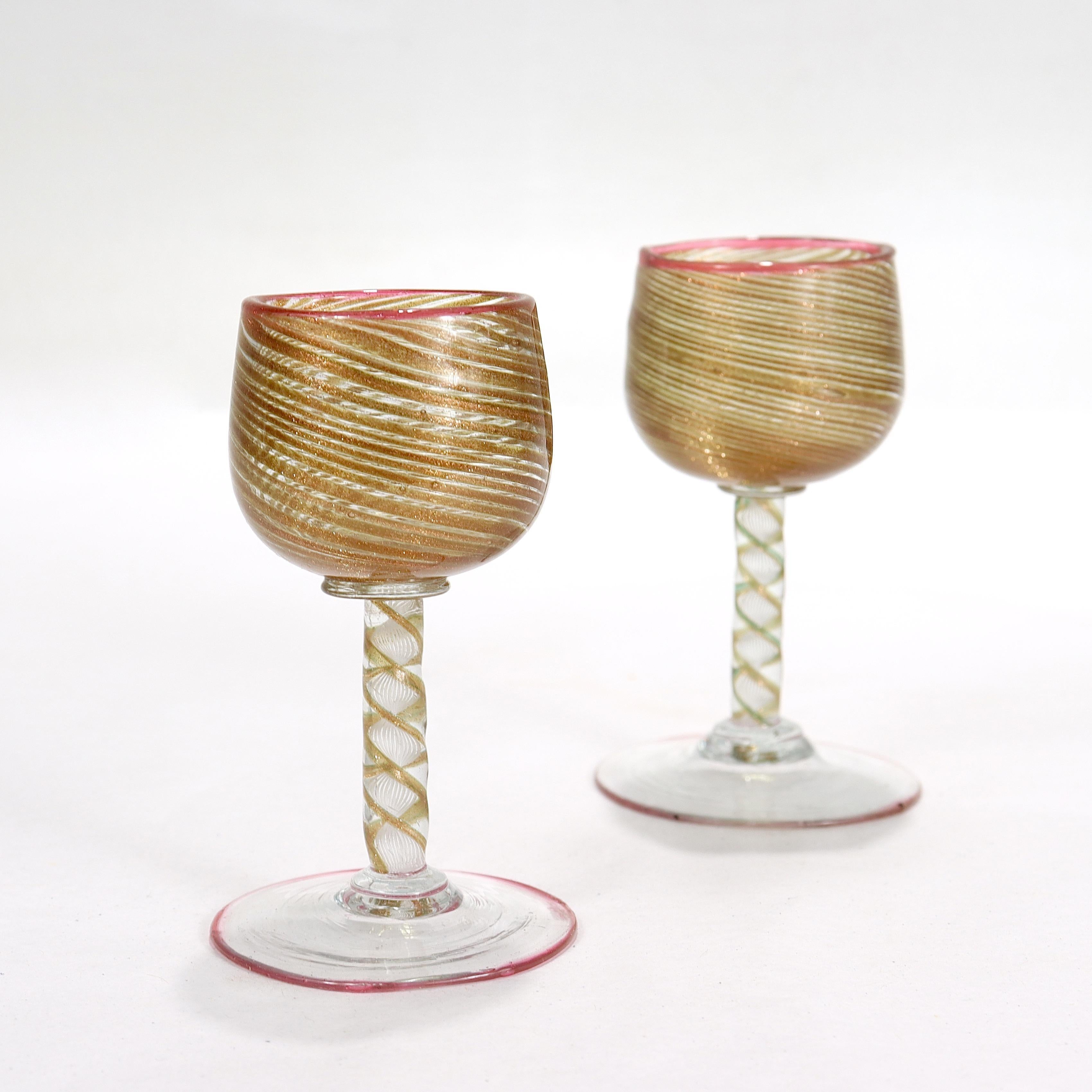 A fine pair of Venetian or Murano glass cordials.

Attributed to Salviati & Co.

With copper aventurine cups supported by a filigrana twist stem and wafer foot.

Both the foot and rim of the cup decorated with a thin applied red thread (one with