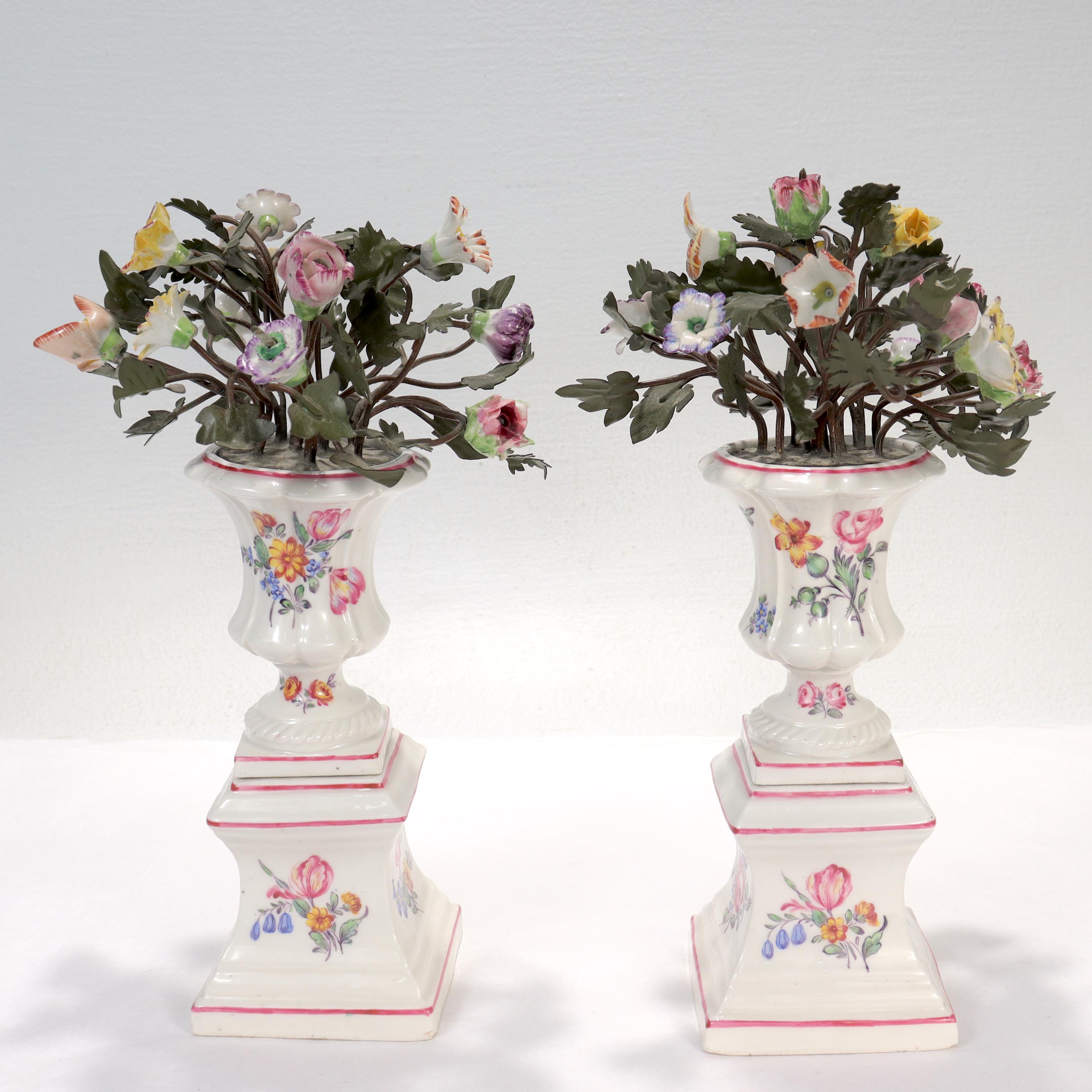 A fine pair of Samson tole peinte & porcelain flower vases or cachepots.

In the 18th Century Mennency style.

In the form of porcelain urns or vases hand painted with floral motifs holding painted 