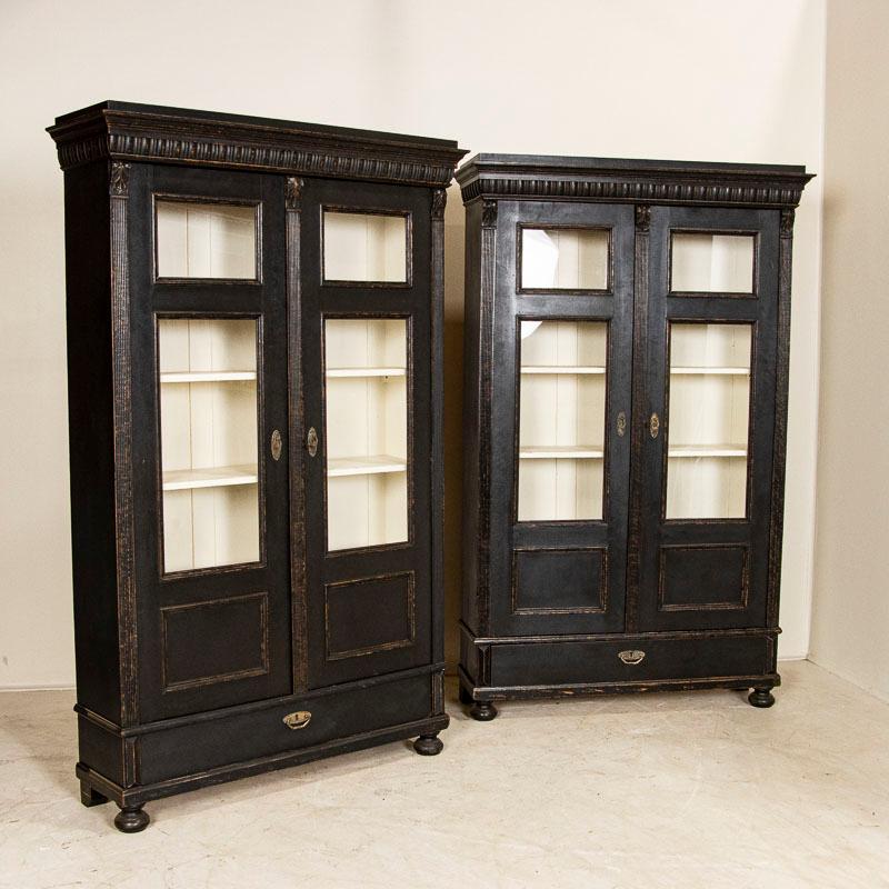It is difficult to find a pair of display cabinets, so this matched set of 2 bookcases makes them a special find. Notice the carved details and open glass display allowing one to show off any collection beautifully. These old cabinets have been
