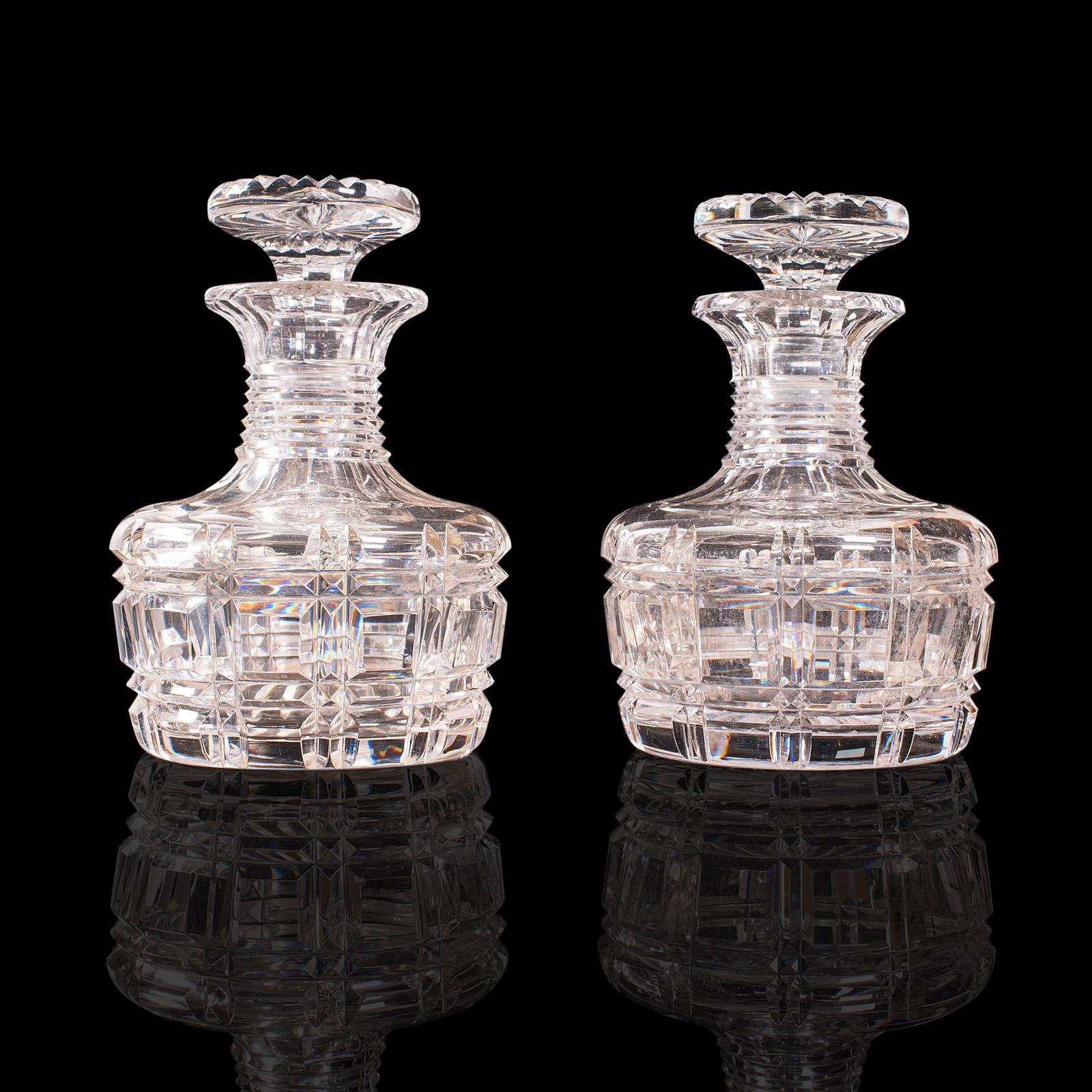 This is a pair of antique sherry decanters. An English, cut glass spirit or liquor flask, dating to the Edwardian period, circa 1910.

Beautifully cut decanters with an eye-catching finish
Displaying a desirable aged patina and in good