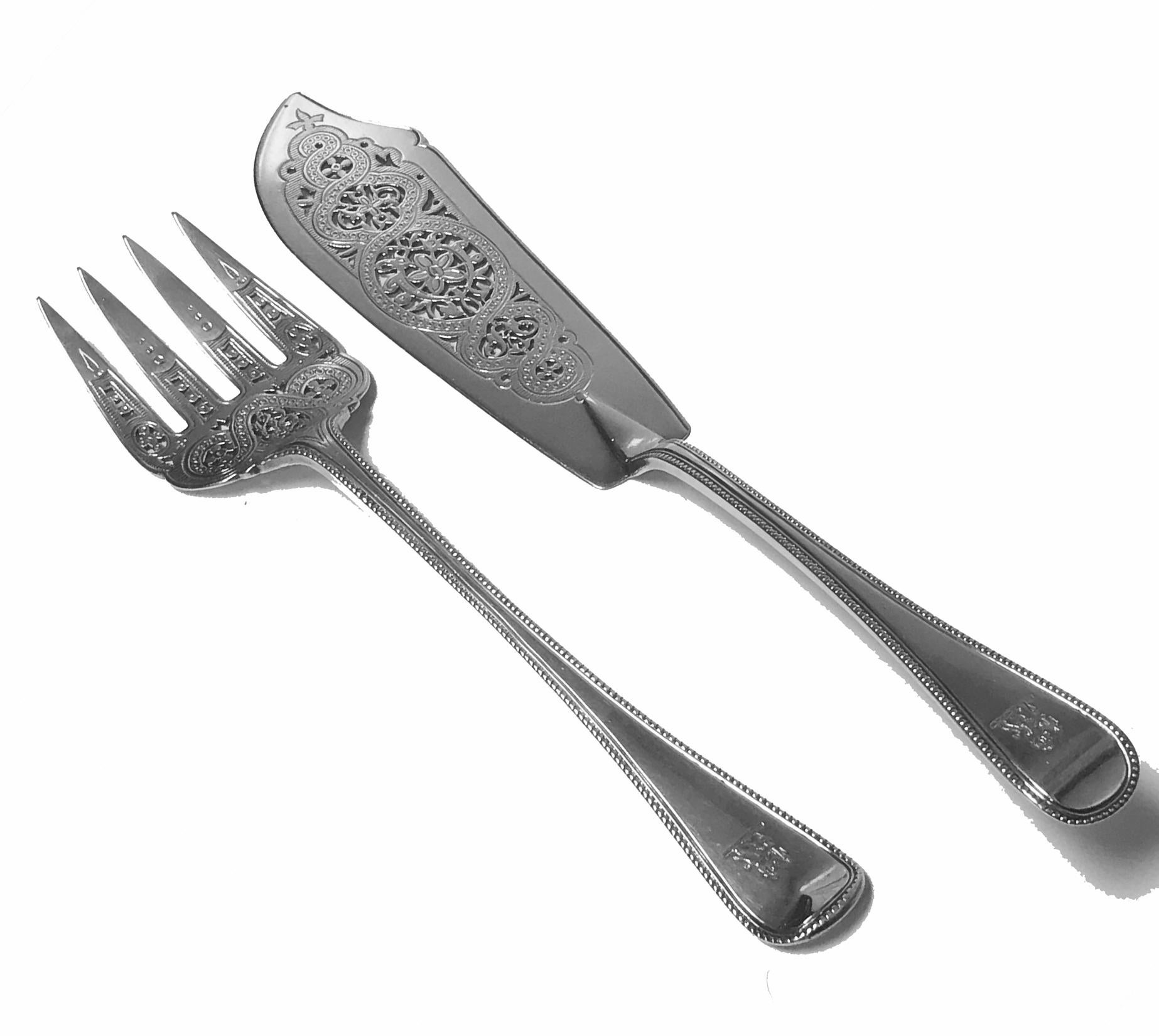 Pair of antique silver fish servers, London 1868 Geo Adams. Bead pattern, engraved crest of a standing lion holding a spear within paws. The blade and tines pierced engraved foliate design. Length of Knife: 11.70 inches. Length of fork: 10.25