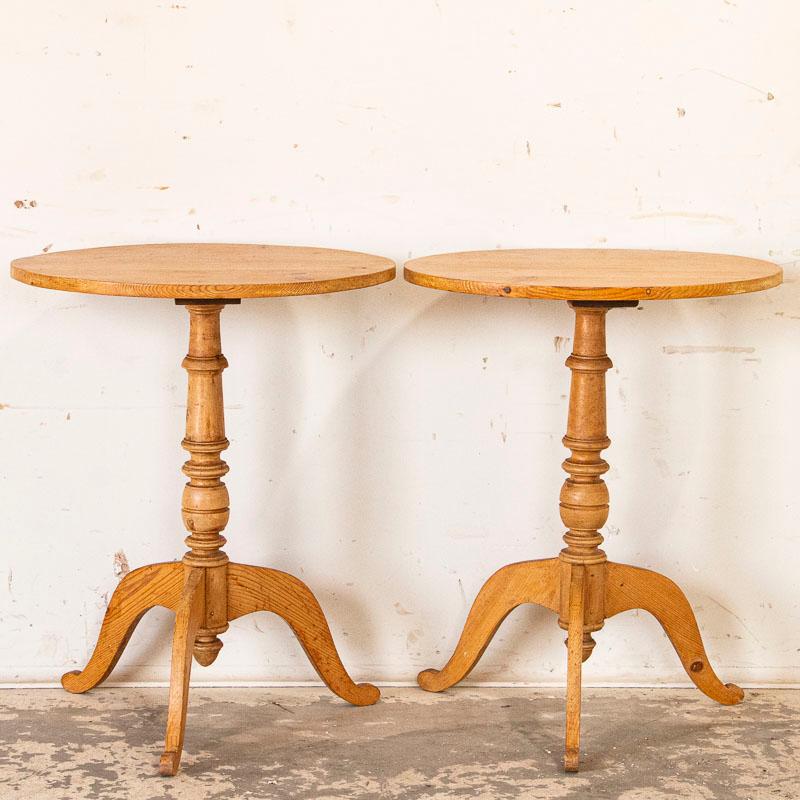 It is rare to find a matching pair of side tables which makes this set a great find. The oval pine top is balanced by the turned pedestal base resting on three pine 