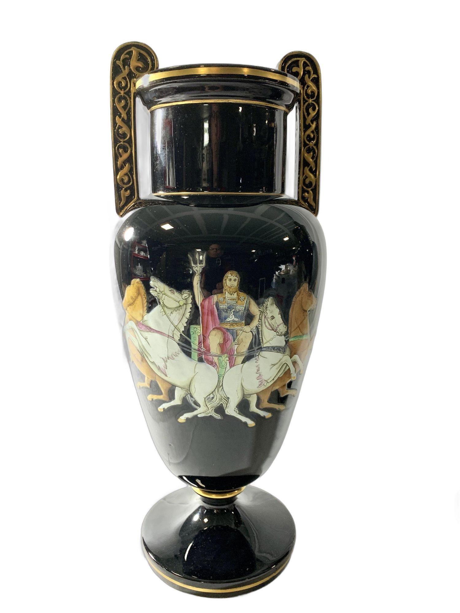 This exquisite pair of antique Staffordshire pottery vases, made in England circa 1880, features mythological scenes of Zeus and Hera riding in their chariots, set against a dramatic glossy black ground.
The detailed artwork, rendered in rich