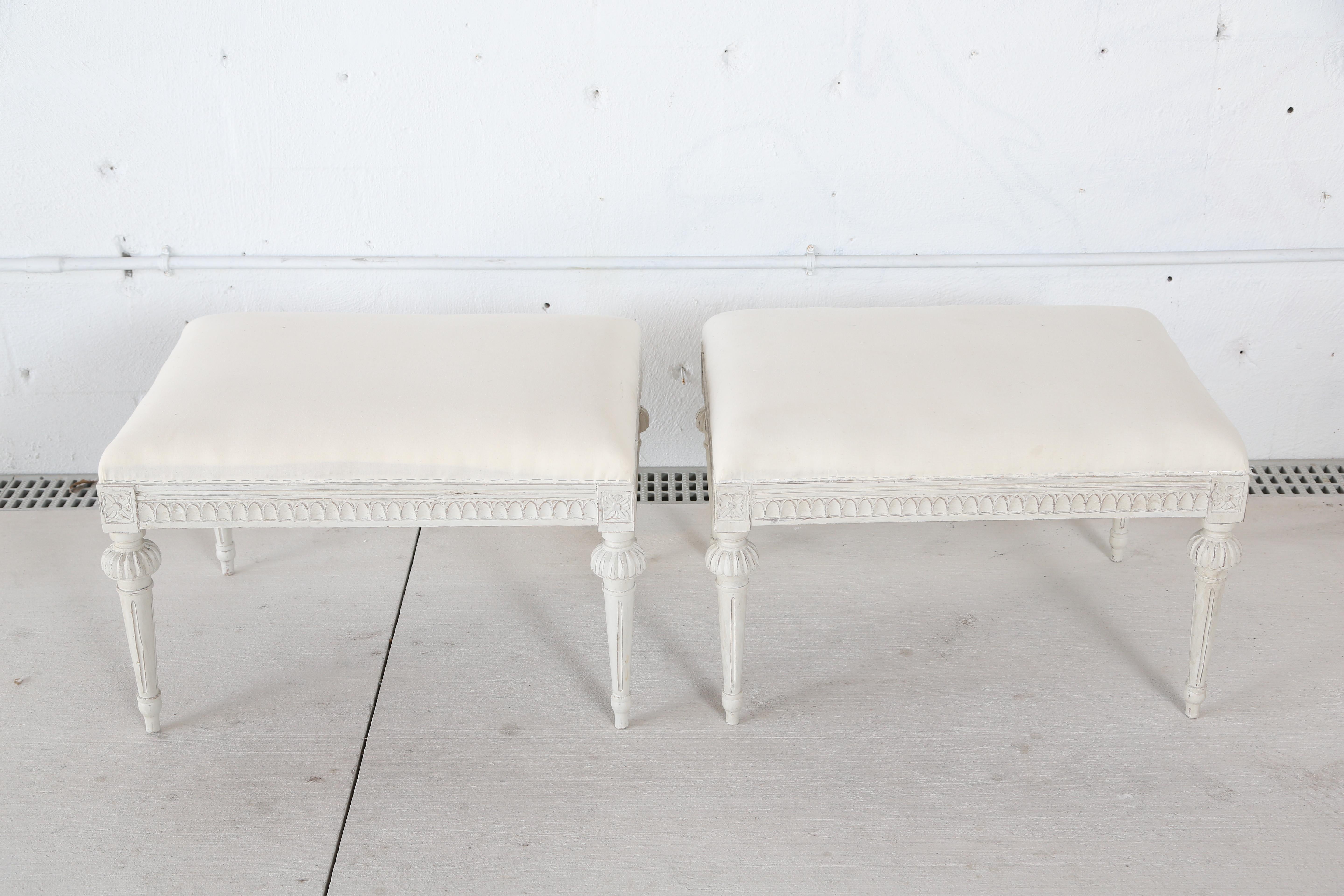 One  antique Swedish Gustavian style stool, with tapered fluted and carved legs. Seat apron edge is beautifully carved with egg and dart design. Wood painted in Swedish white color. Upholstered seat top
on white muslin, circa 1900-1910.

One of the