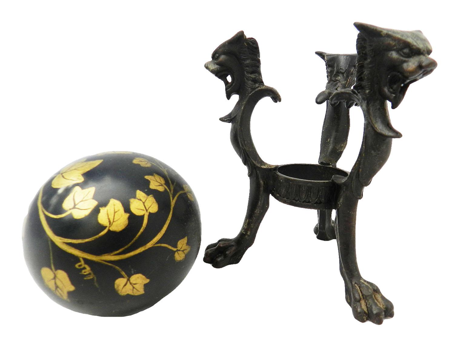 Pair of 19th century neoclassical bronze decorative tripod stands with chimera supporting a decorative ball painted with trailing Ivy
Stands have lion paw feet with dragon heads
Very unusual and handsome
The bronze stands have a good patina
Balls