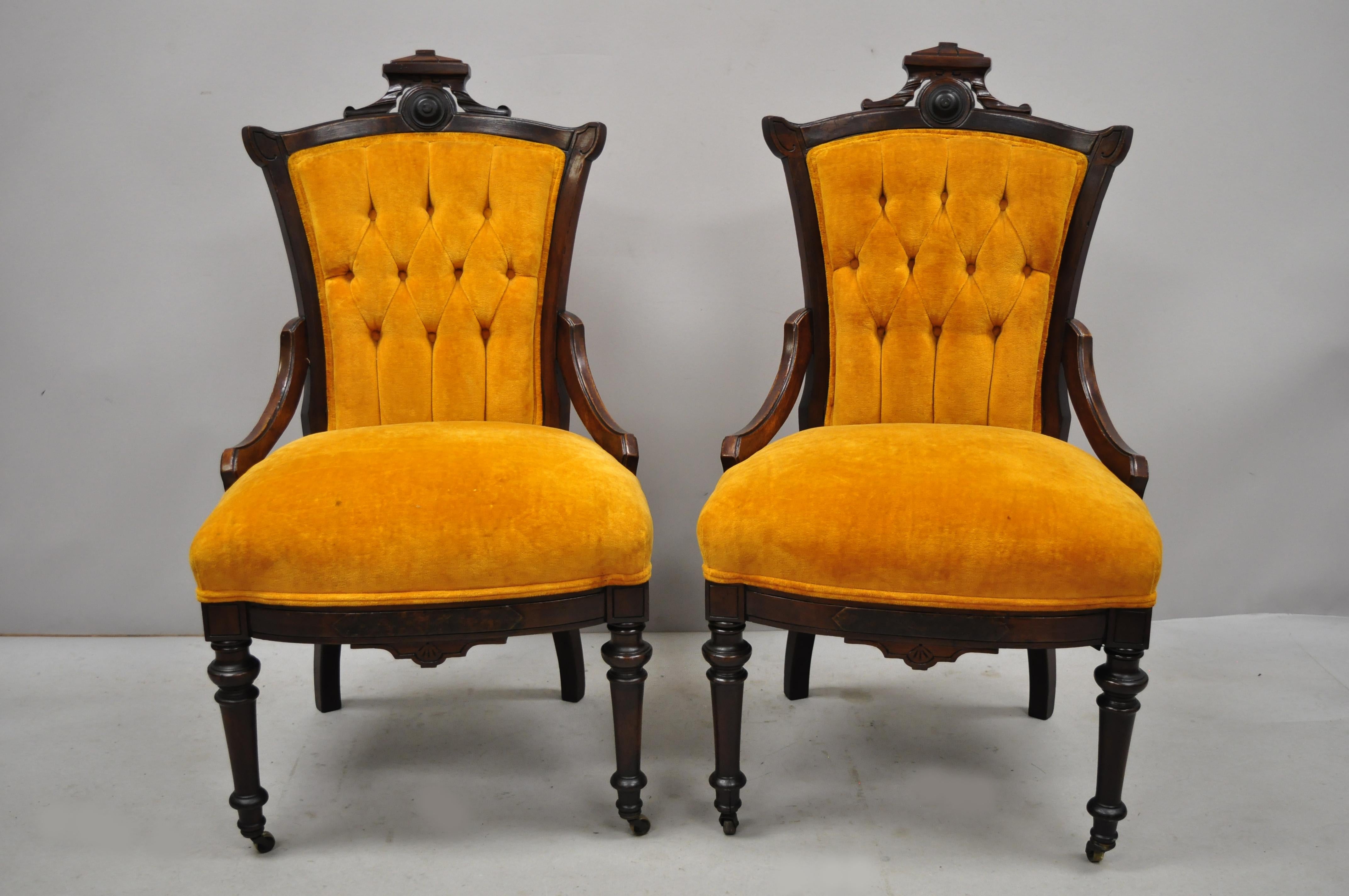 Pair of antique Victorian Eastlake carved walnut orange tufted parlor side chairs. Pair of includes tufted backs, orange upholstery, rolling casters, solid wood frame, beautiful wood grain, nicely carved details, very nice antique item, circa 19th