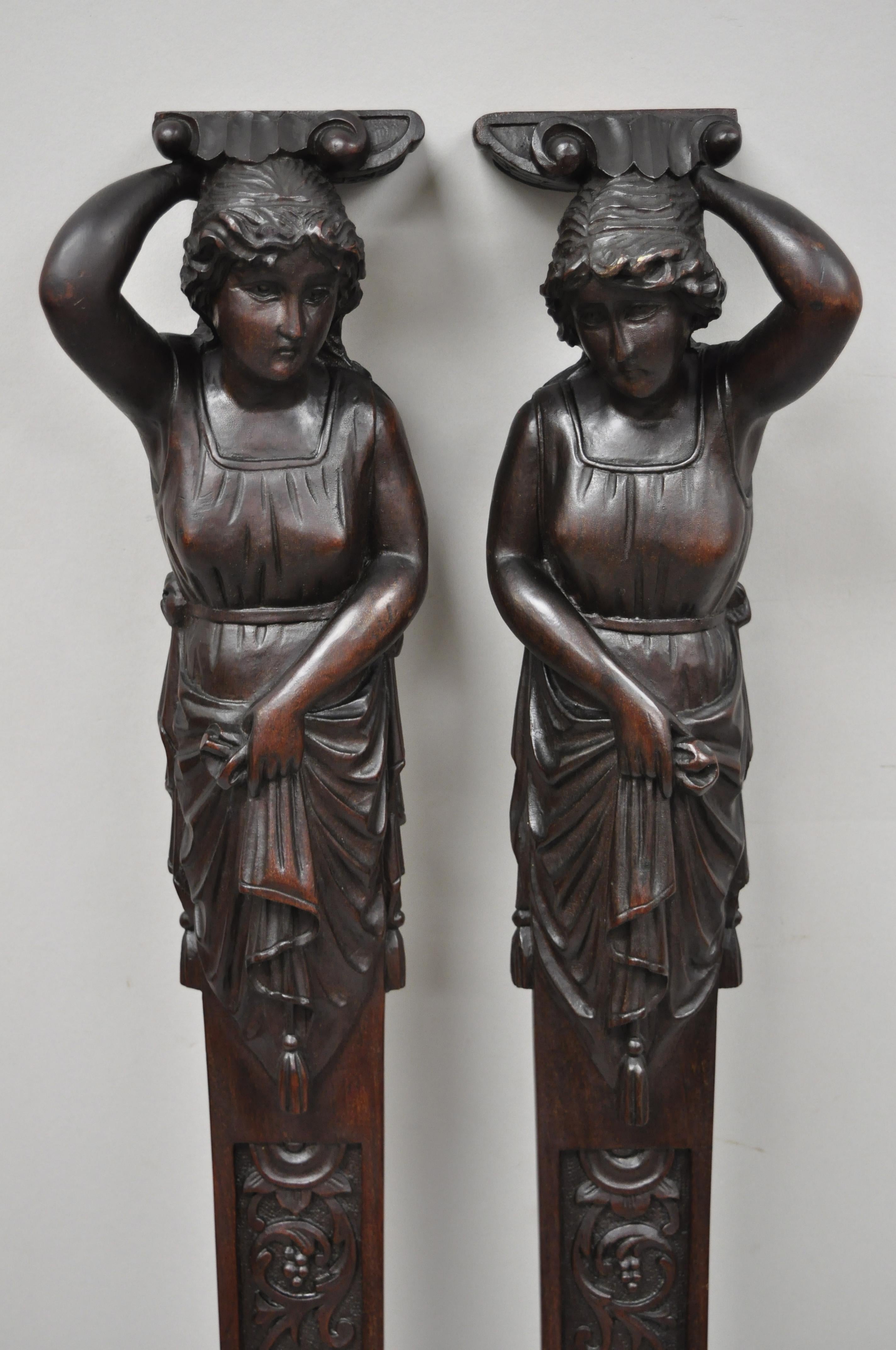Pair of antique Victorian hand carved mahogany figural maiden architecture. Listing includes right and left maiden forms, carved leafy scrollwork, finely hand carved details, remarkable detail, solid wood construction, very nice antique set, circa
