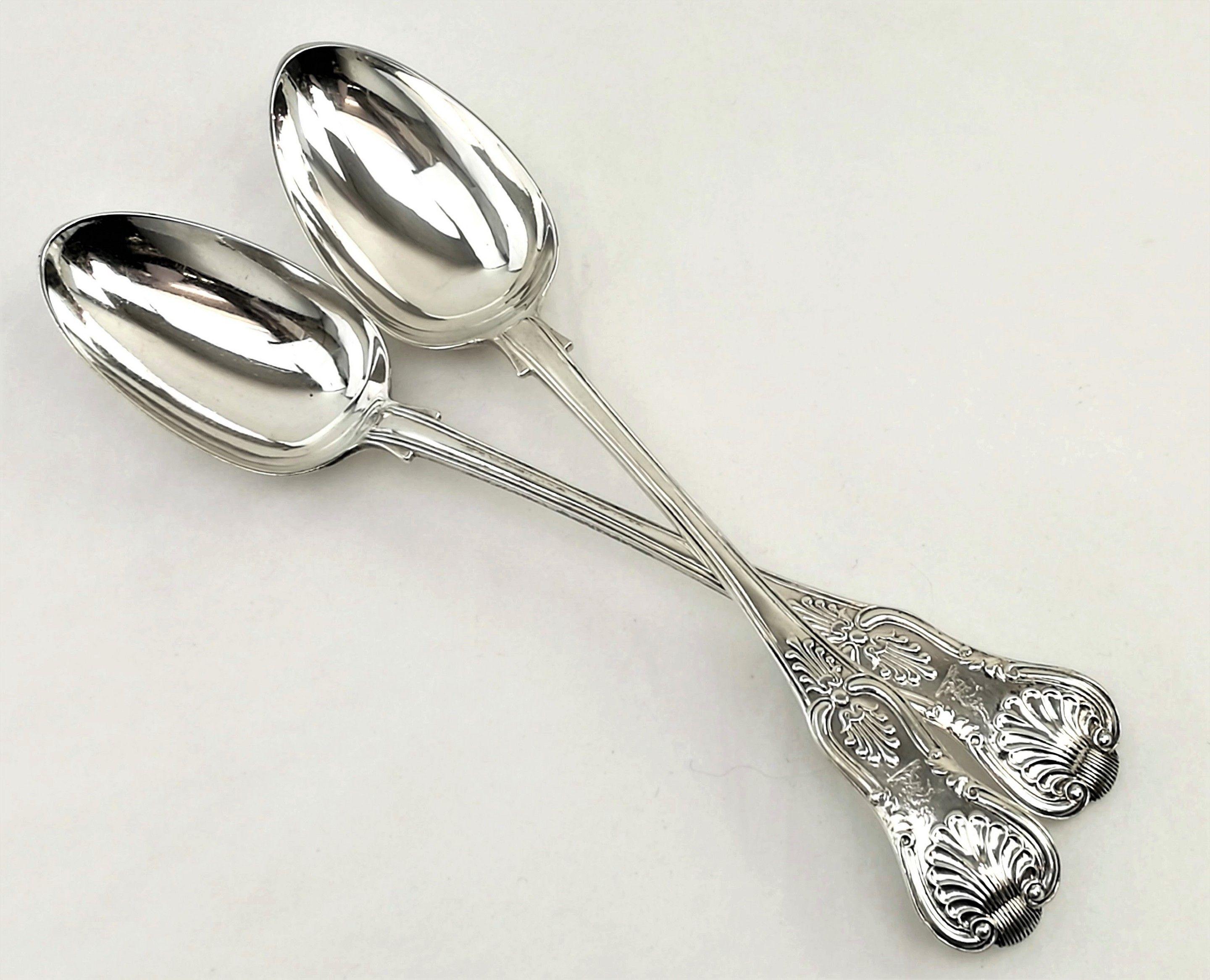 A pair of antique Victorian sterling silver serving spoons / basting spoons in a Classic Kings pattern. These double struck spoons are of a heavy weight and excellent quality. Each has a tiny crest engraved on the handle.
 
 Date: 1838.
 Made in