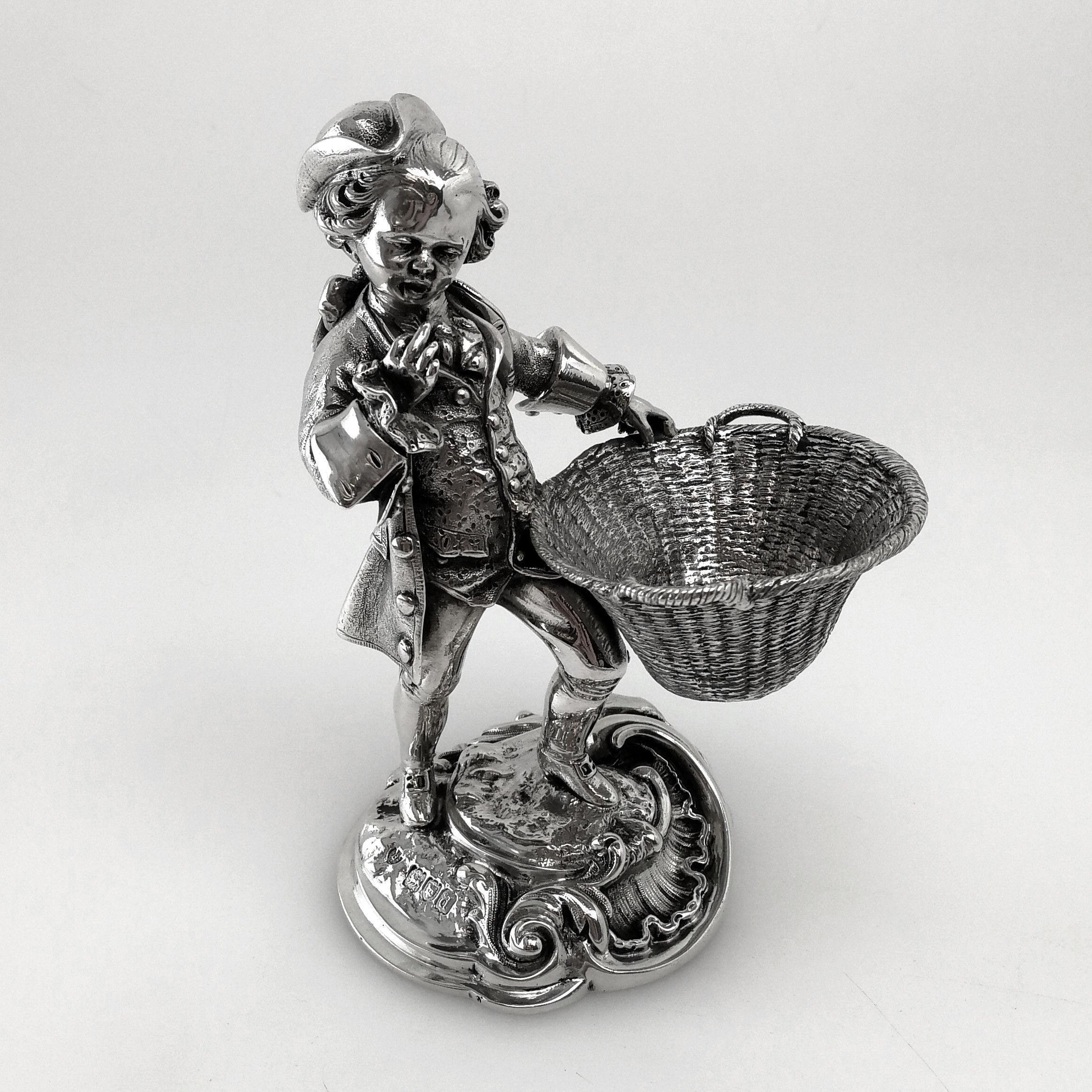 A pair of magnificent cast solid silver Antique Victorian Table Salts / Salt Pinch Pots. The Figural Salts are cast in a pair of Male & Female Figures in period dress each holing a wide oval woven basket in their hands. The man is dressed in a Tri -