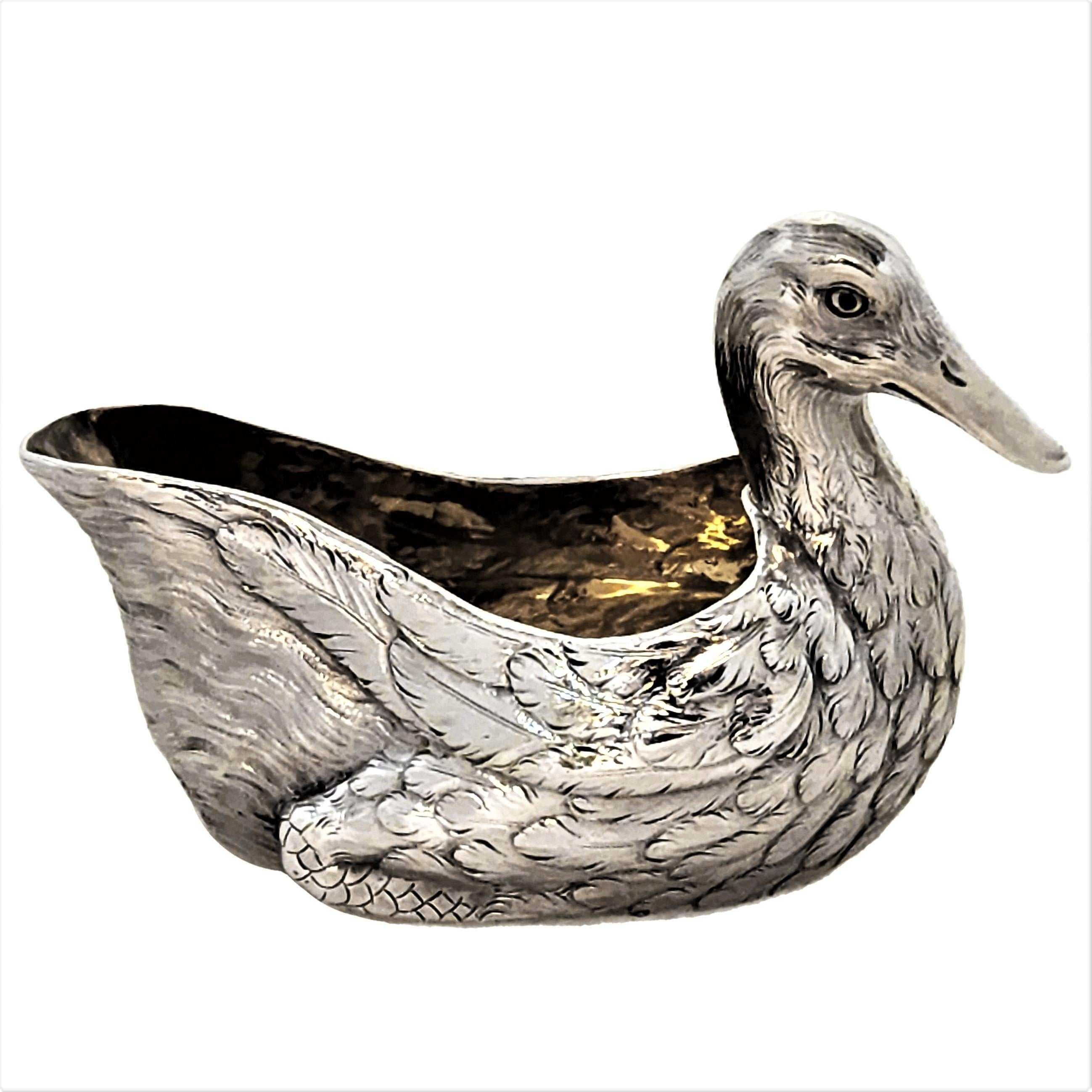 A pair of wonderful Antique Victorian Silver Cream Boats in the shape of Ducks. Each Duck Milk Jug is modelled with a charming attention to detail. The Salts are gilded on the inside and have inset glass eyes. Each Cream Boat has the word QUACK