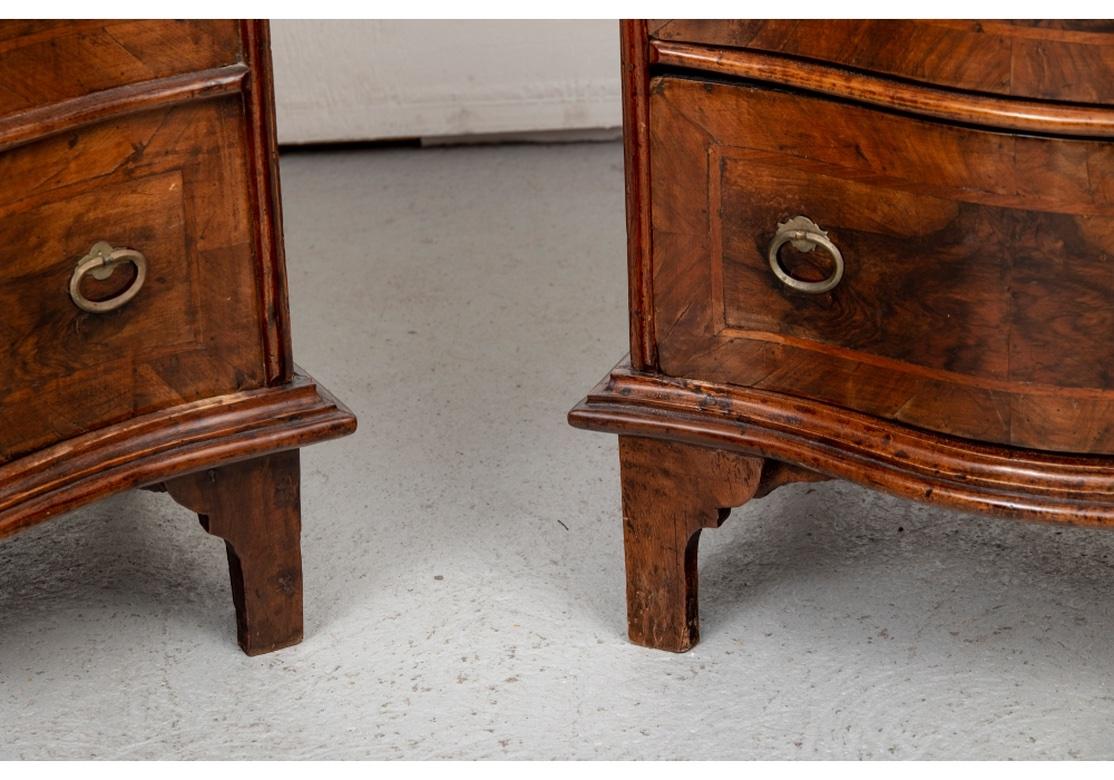 A Pair of Antique Chests suitable as Night Stands or Side Tables having particularly handsome wood and fine compact form. Shaped chests with three cross-banded figured drawers on one, and the other with matching faux drawers with a lift top and
