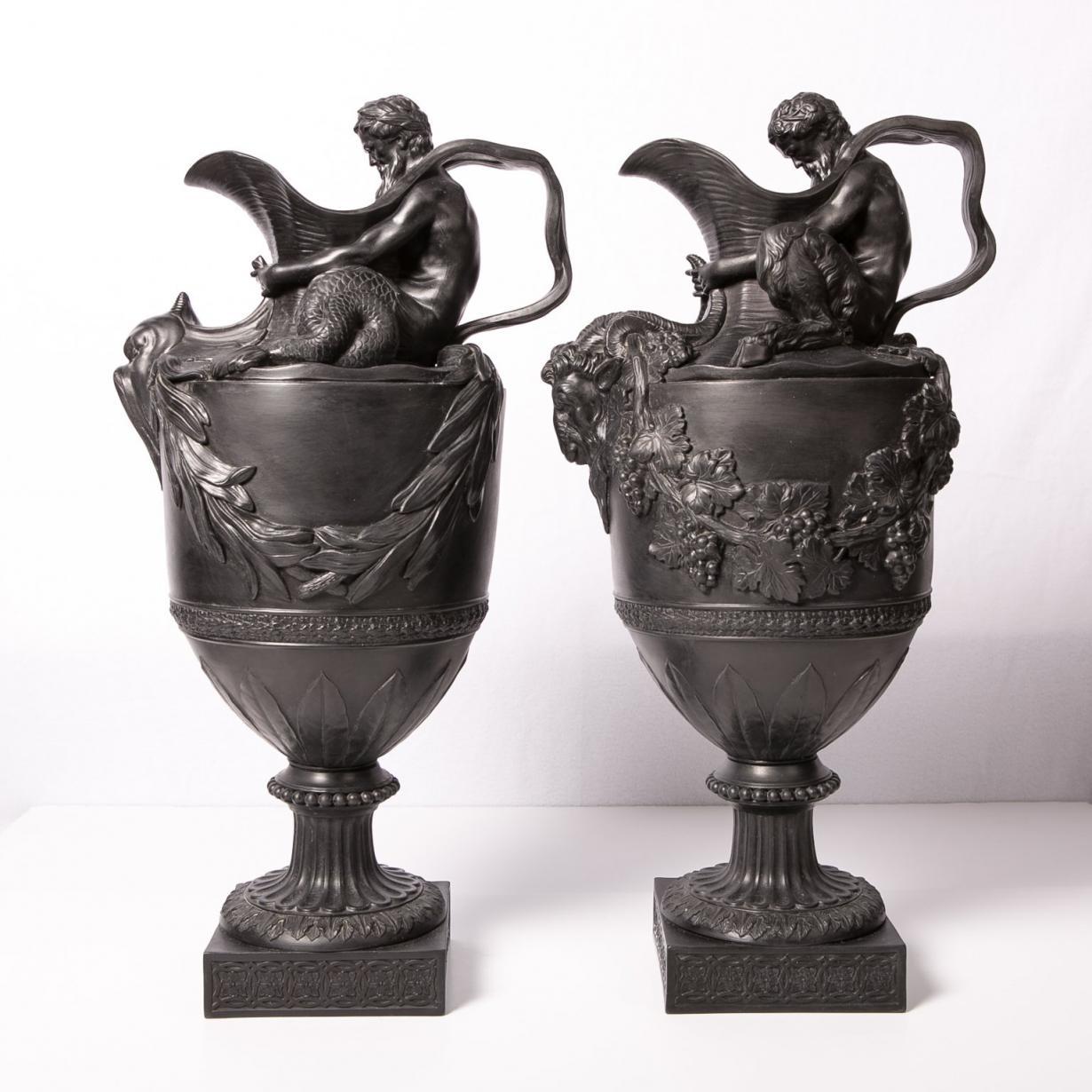 A pair of antique Wedgwood black basalt wine and water ewers named: 