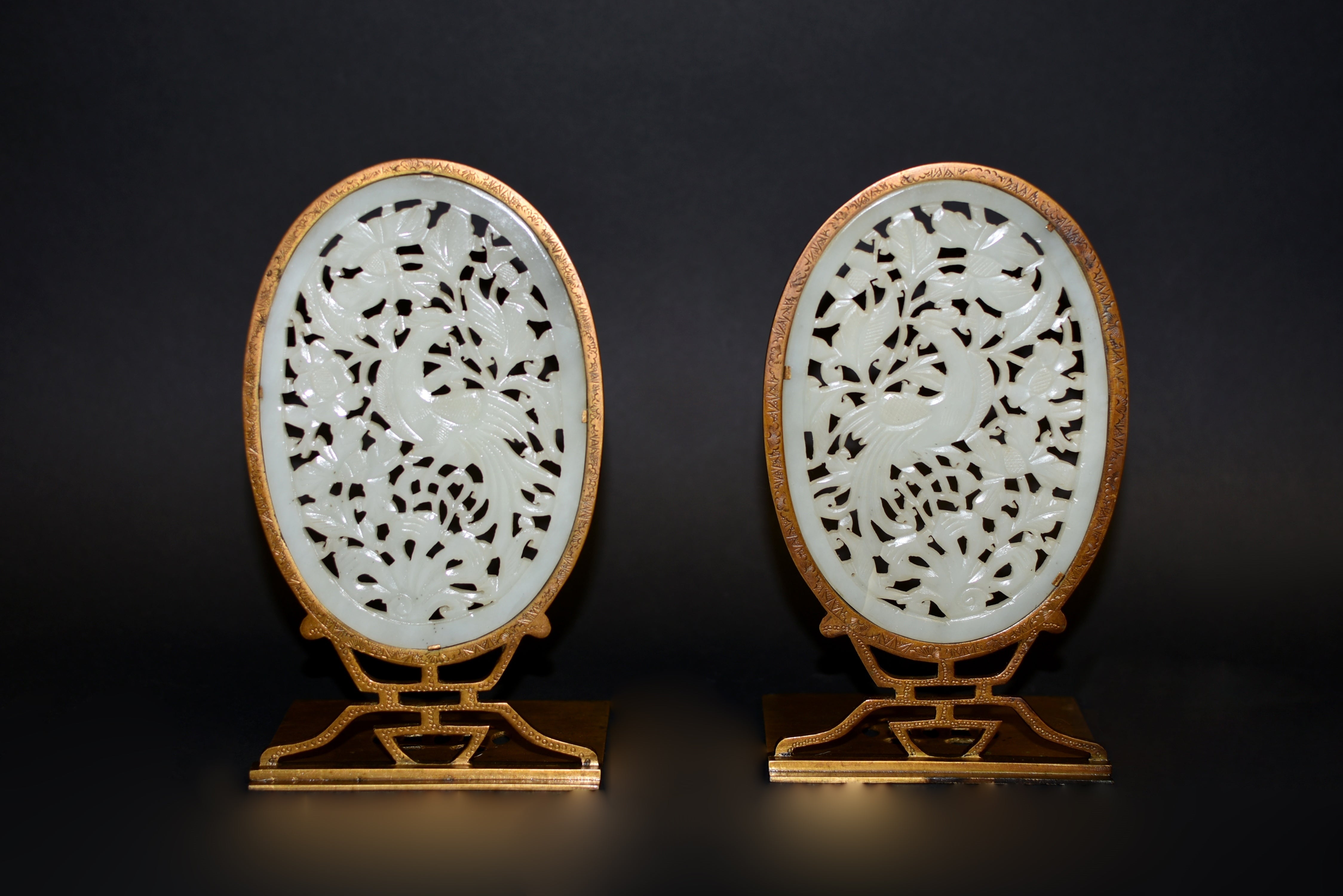 A pair of extraordinary bookends with large oval he-tian white nephrite jade insets. In the form of ovoid, the 4