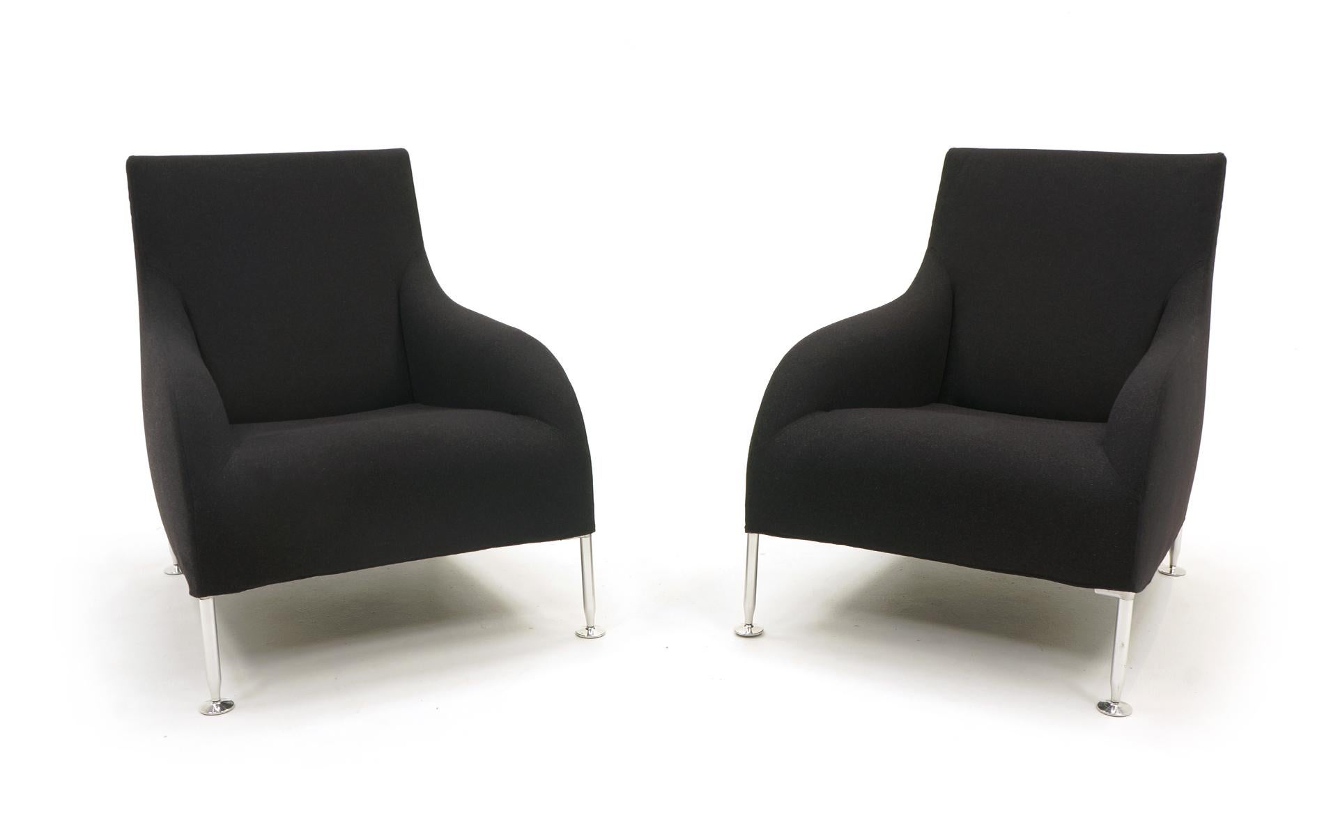Pair of lounge chairs with pullout / pull-out footrest by Antonio Citterio for B&B Italia. Black wool felt upholstery with chromed steel legs. Pullout / pull-out ottoman of perforated steel. Very heavy and well constructed. Very comfortable.