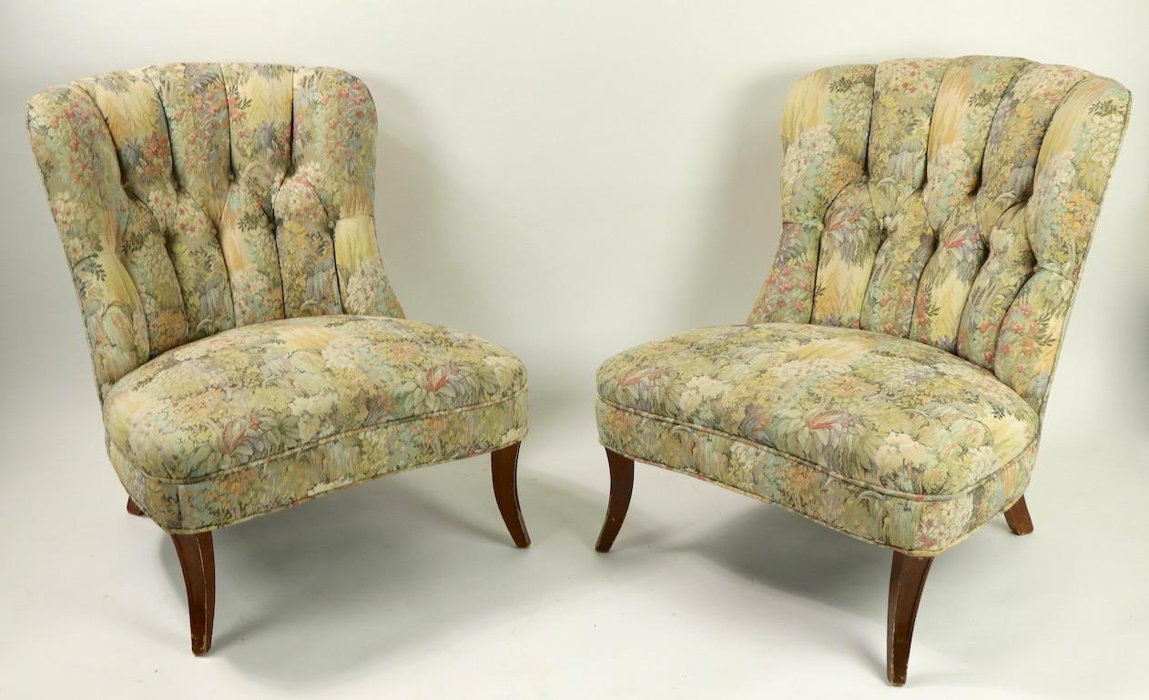 Very chic and stylish pair of low slung lounge, or slipper chairs in original fabric. These chairs are well crafted, having tied spring upholstery and solid wood frames.
Design reminiscent of Classic Ernst Schwadron chairs. Both chairs are solid