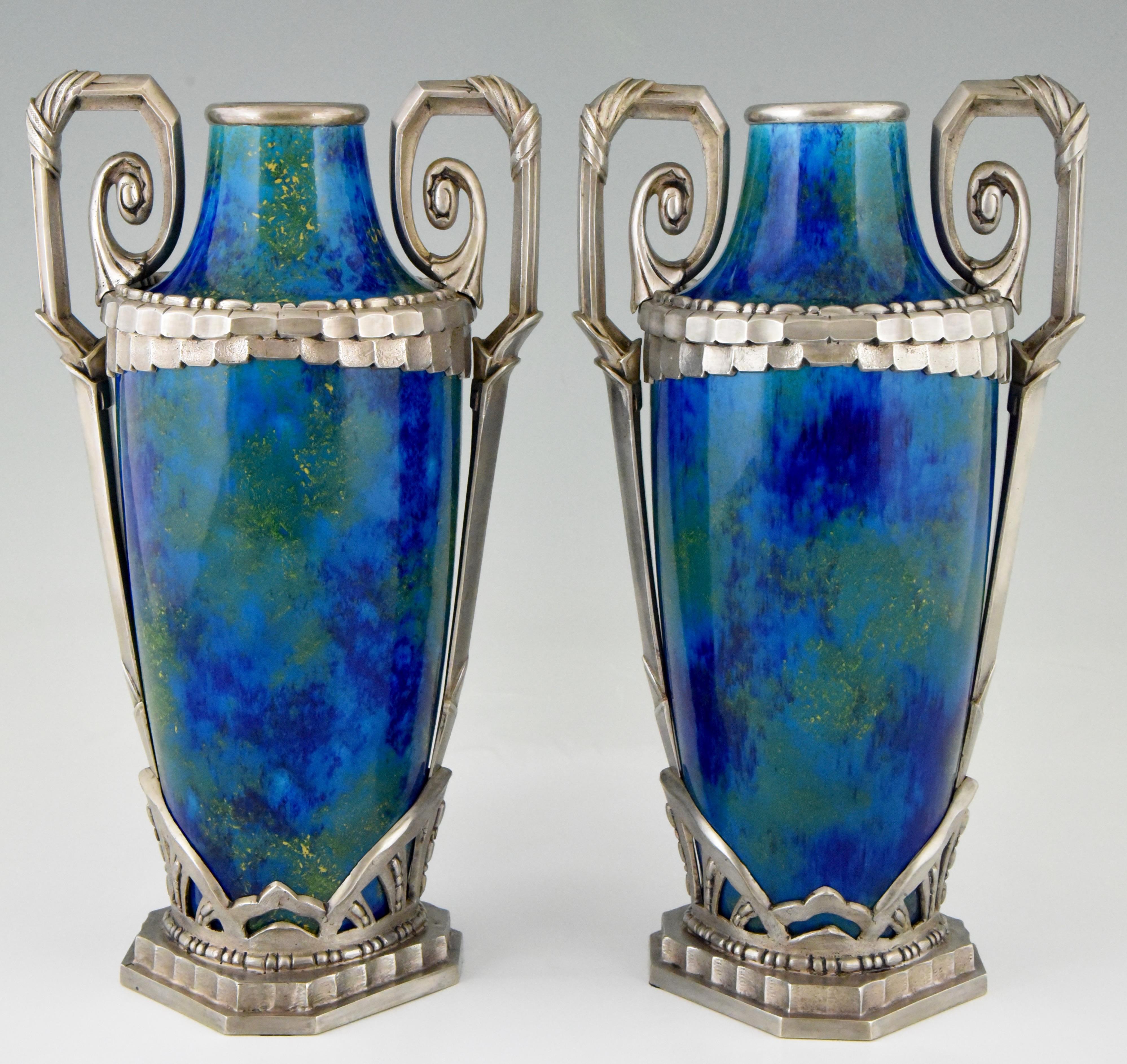 A pair of French Art Deco ceramic vases with “blue flambé” glaze and silvered bronze mounts.
There are gold specks in the intense colored green/blue glaze.
Designed by Paul Milet (1870-1950) for Sèvres, France, 1920. 

Literature:
The