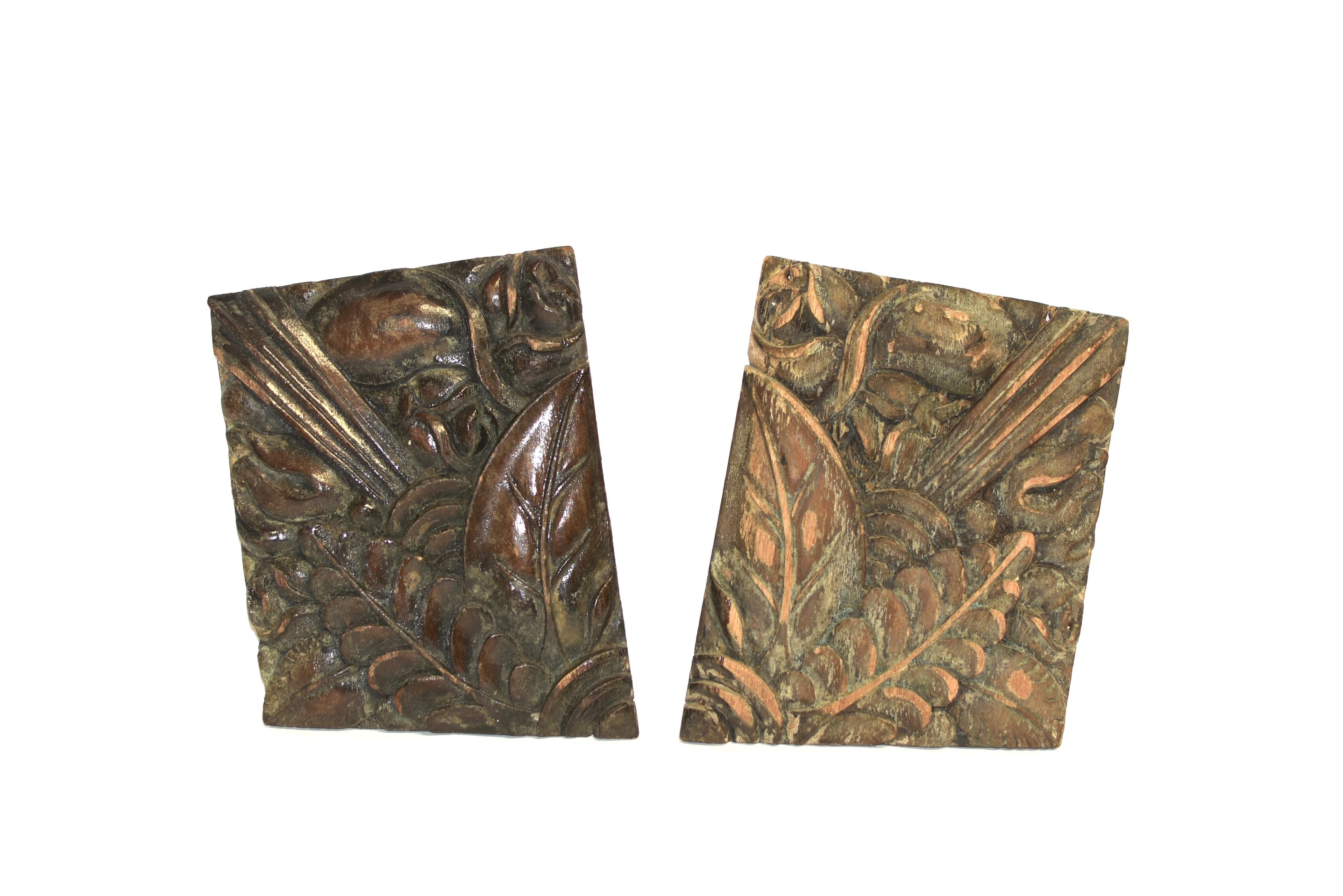 A pair of wood fragments carved in high relief with overlapping leaves of magnolia and mimosa, fronting blossoms of magnolia and reeded fractions of columns. Hand carved, solid wood, from the Chinese republic era.