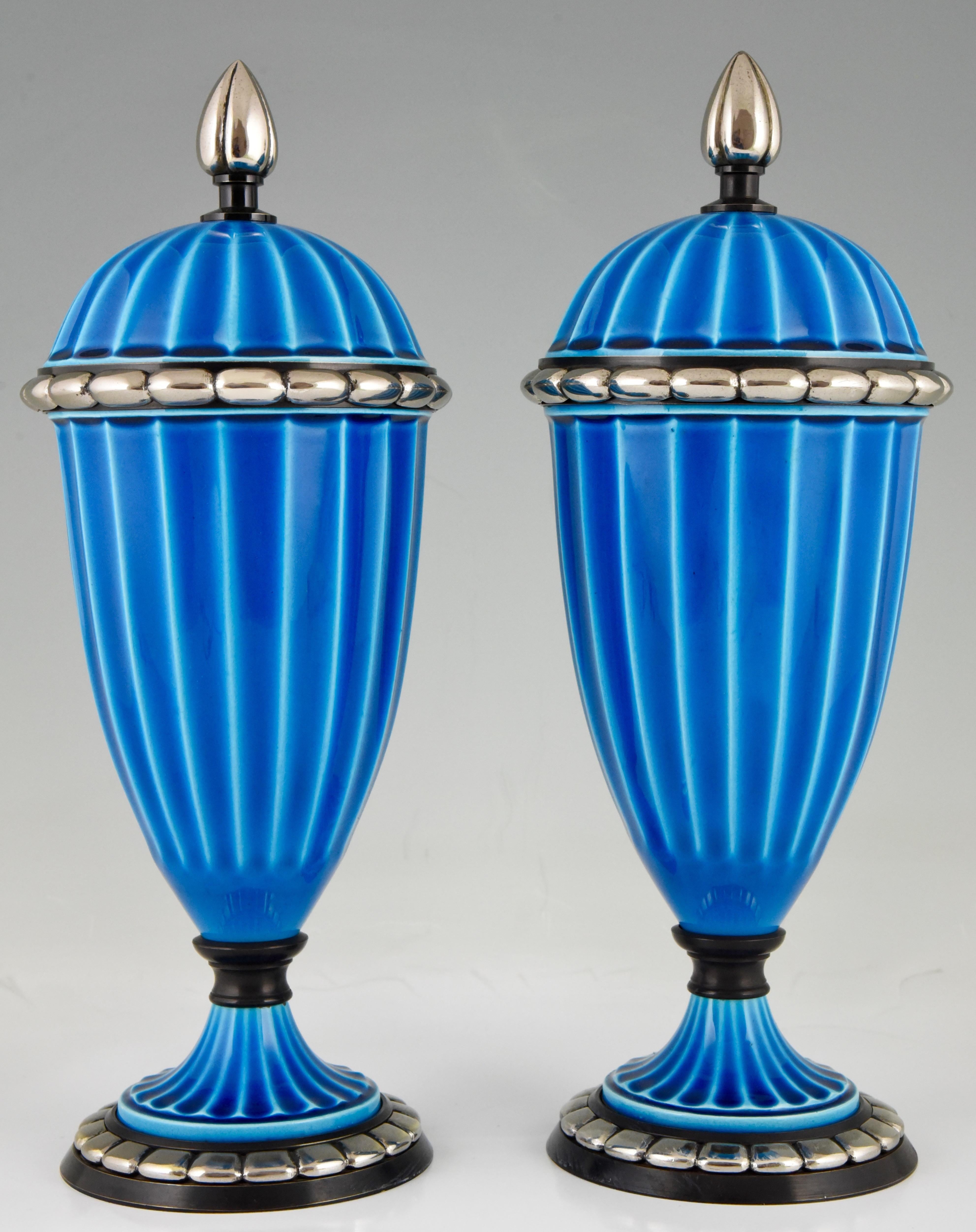 A pair of blue Art Deco ceramic vases or urns with blue glaze by Paul Milet for Sèvres. The vases have bronze decorations with silver patina, France, 1925.

“The Encyclopedia of Decorative Arts 1890-1940” By Philippe Garner. ?“Art Deco Keramik” by