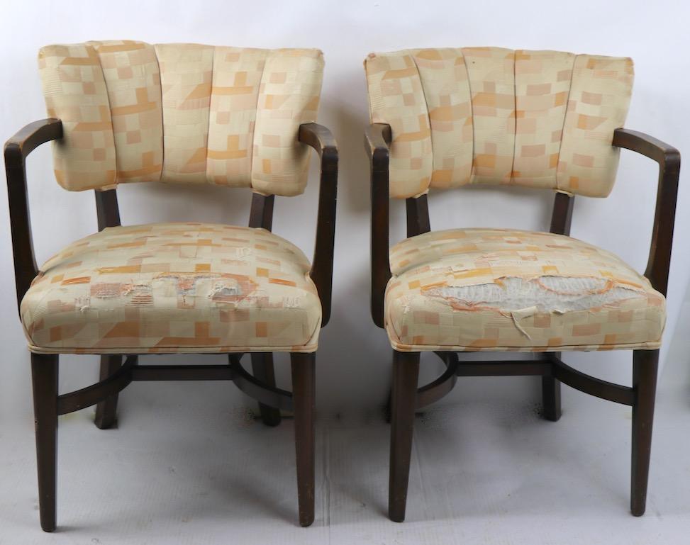 Pair of stylish Art Deco armchairs, in the style of Rohde. Solid wood frames with upholstered tied spring upholstered seats, and upholstered backs, fabric worn and will need to be replaced, wood frames sturdy but show cosmetic wear. Offered and