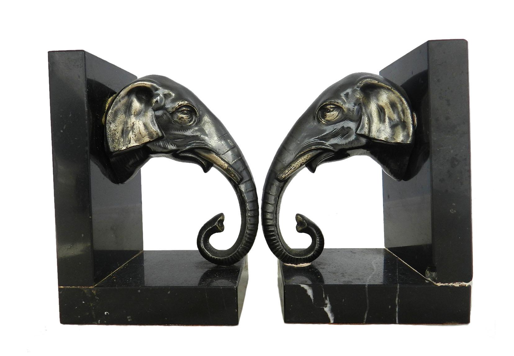 Pair of Art Deco elephant head bookends, French, circa 1930
Patinated spelter on black marble
Good condition with some minor signs of wear for their age, one small chip on marble to one very hard to notice.



              