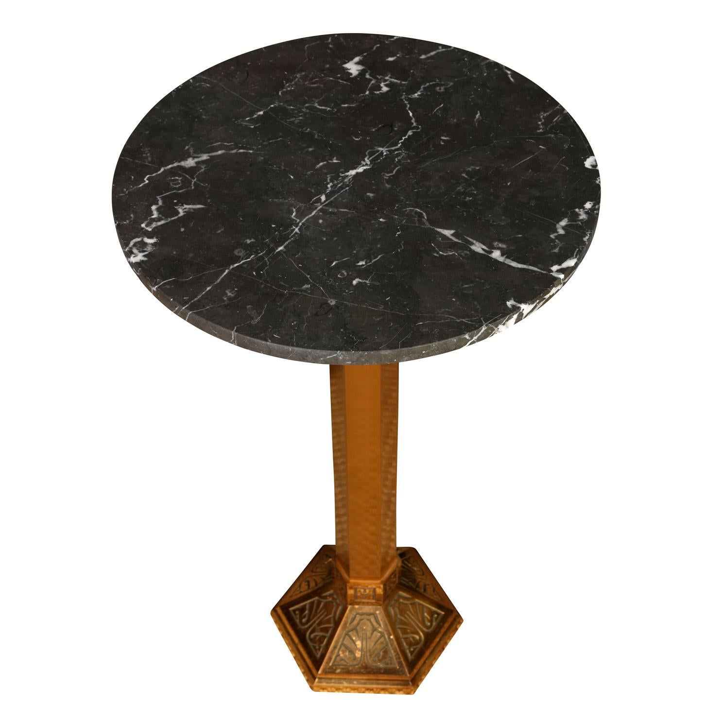 A pair of Art Deco style drinks tables, each with a deco detailed hexagonal brass base and round black marble top.