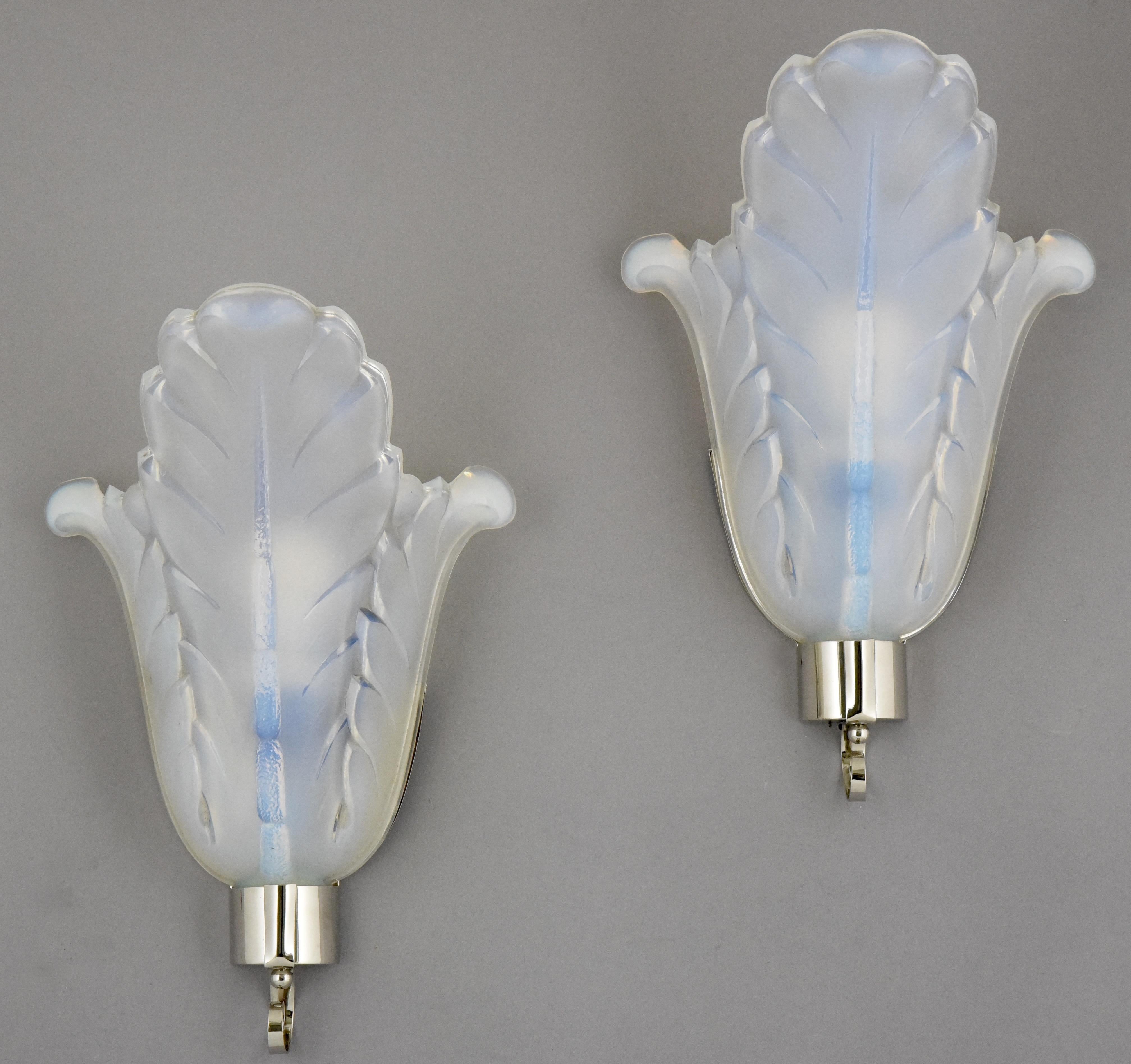 Beautiful pair of Art Deco wall lights or sconces signed by Ezan, France.
Opalescent glass and silvered bronze frame, circa 1930.
  