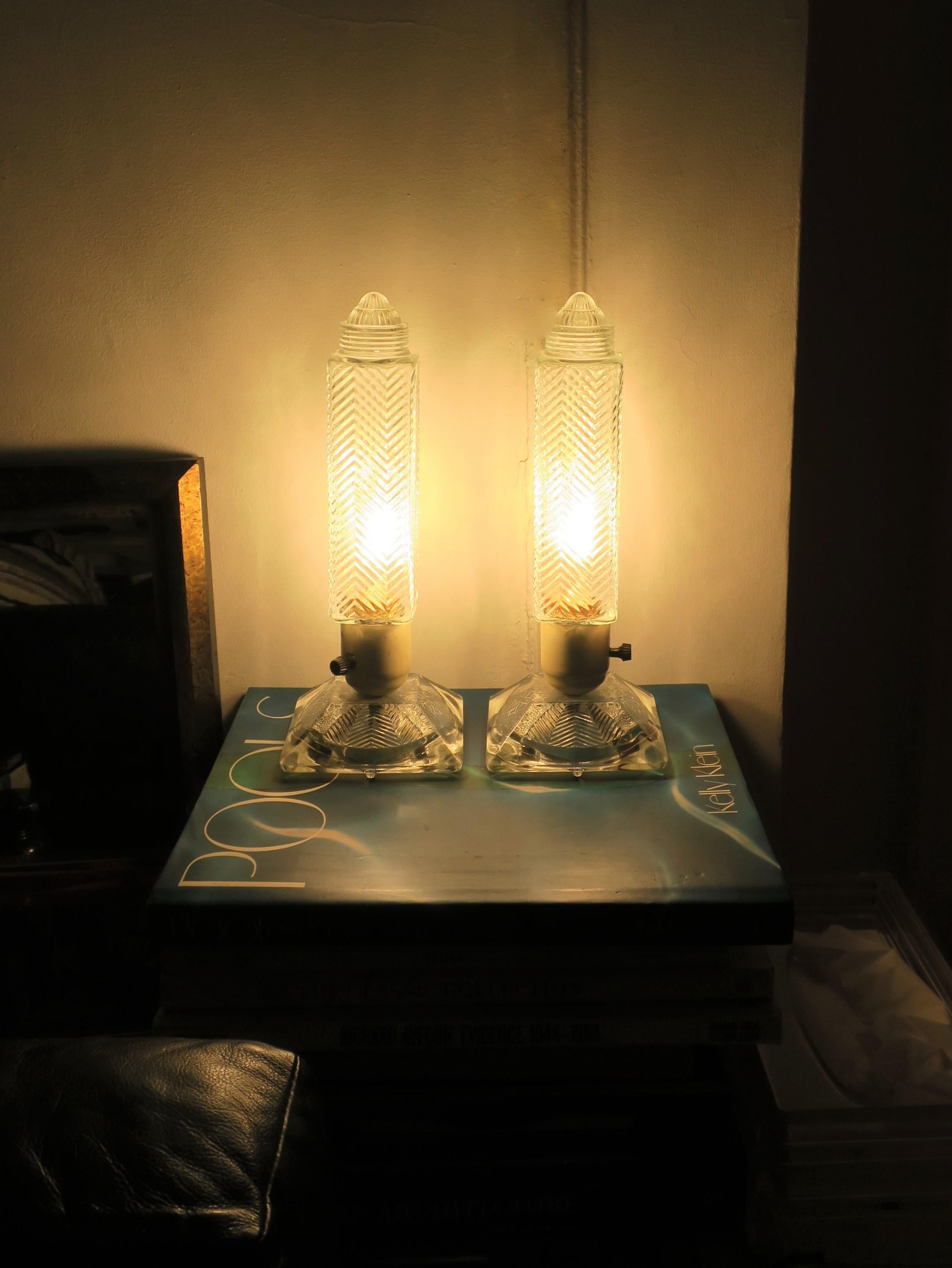A pair of Art Deco period glass table or bedside/nightstand lamps, circa 1930s. Lamps shown in 'on' position with new 25W frosted bulb. Dimensions: 4.63