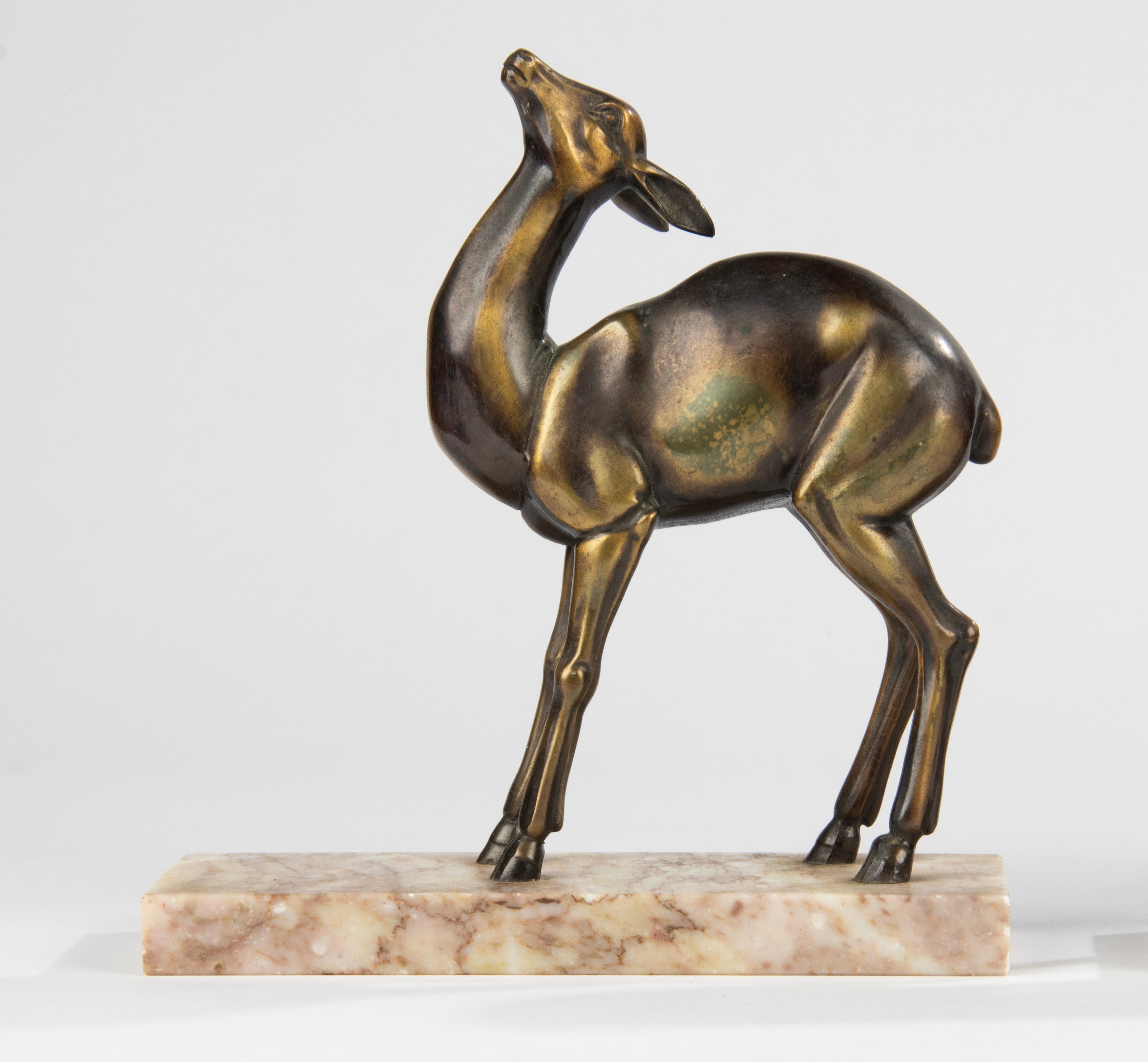 Pair of Art Deco period book ends with sculptures of deer. Made of casted spelter, patinated in multi color, brown and bronze-like color, on marble bases. In good condition with minor signs of age. Made in France around 1920-1930.
Dimensions: 21