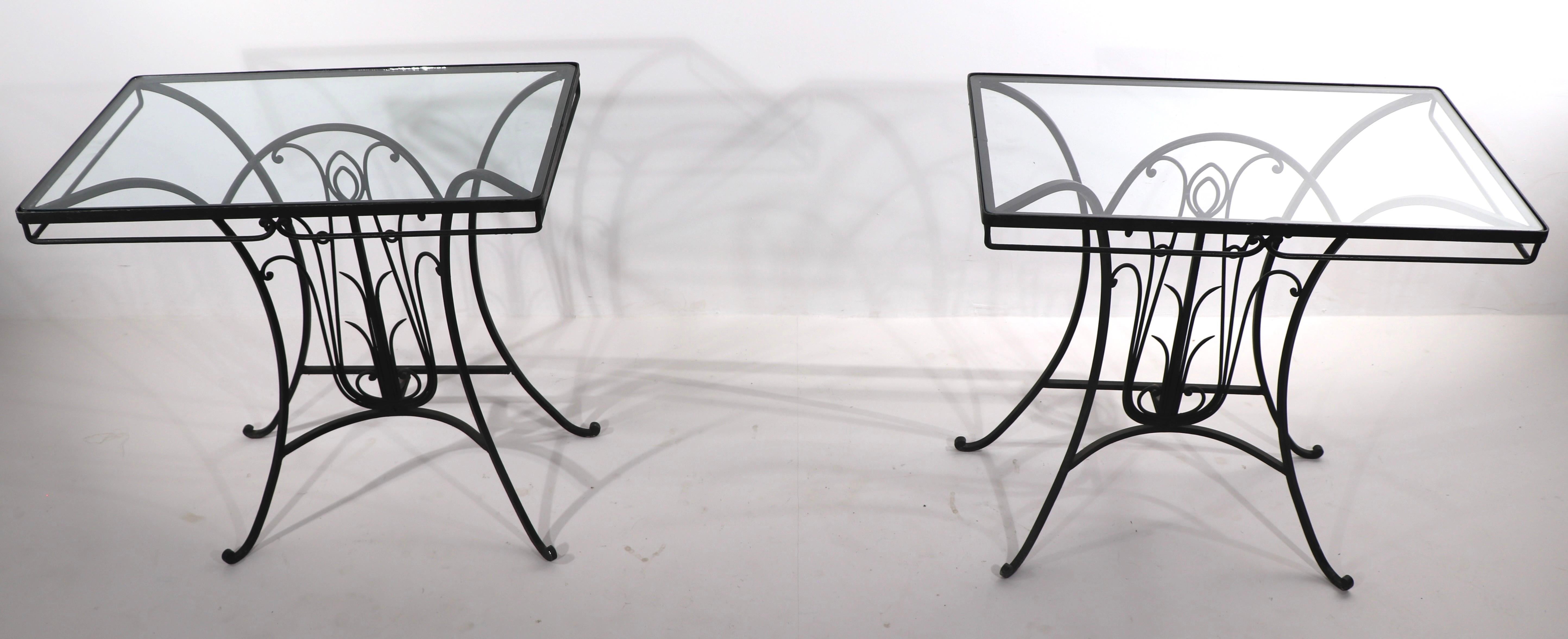 Rare pair of Art Deco period wrought iron and glass consoles, attributed to Salterini. Both tables are in very good condition, clean and ready to use. Hard to find this model, especially hard to find in pairs. Suitable for both indoor and outdoor