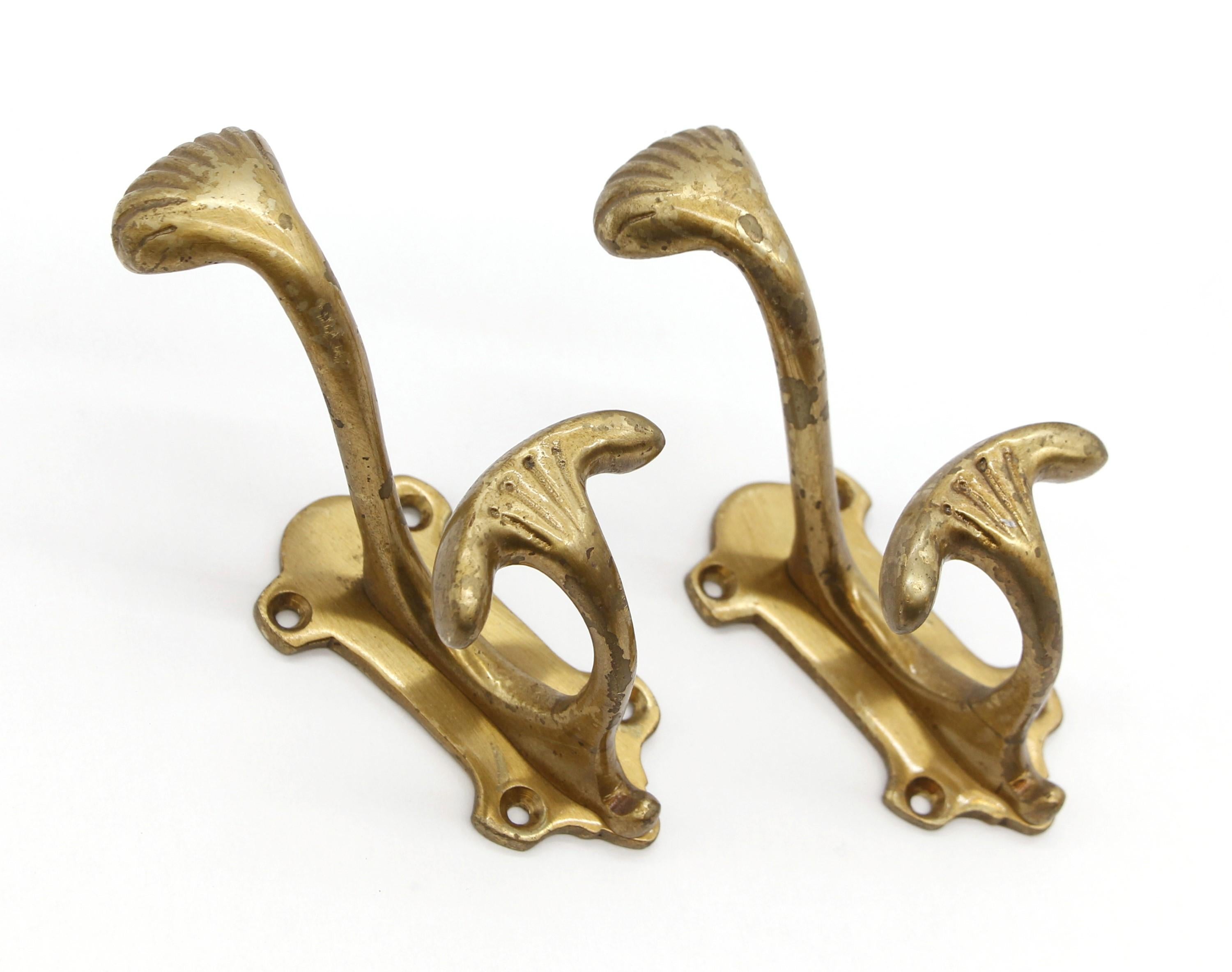 Early 20th Century brass double arm hooks with an Art Deco style. Good condition with appropriate wear from age. Priced as a pair. Please note, this item is located in our Scranton, PA location.