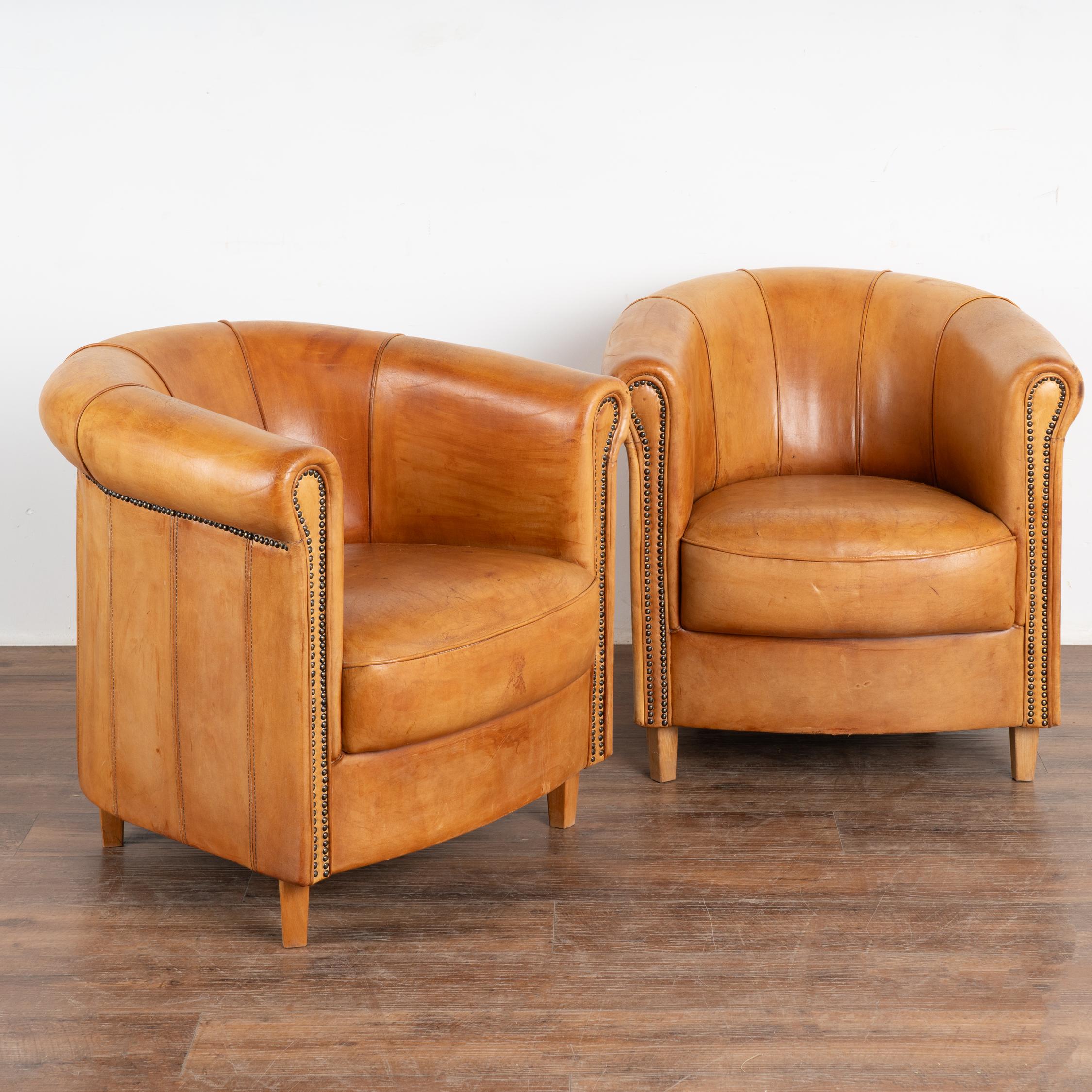 Pair, art deco style club chair by Joris of the Netherlands in camel tone leather. Plaque on back noting 