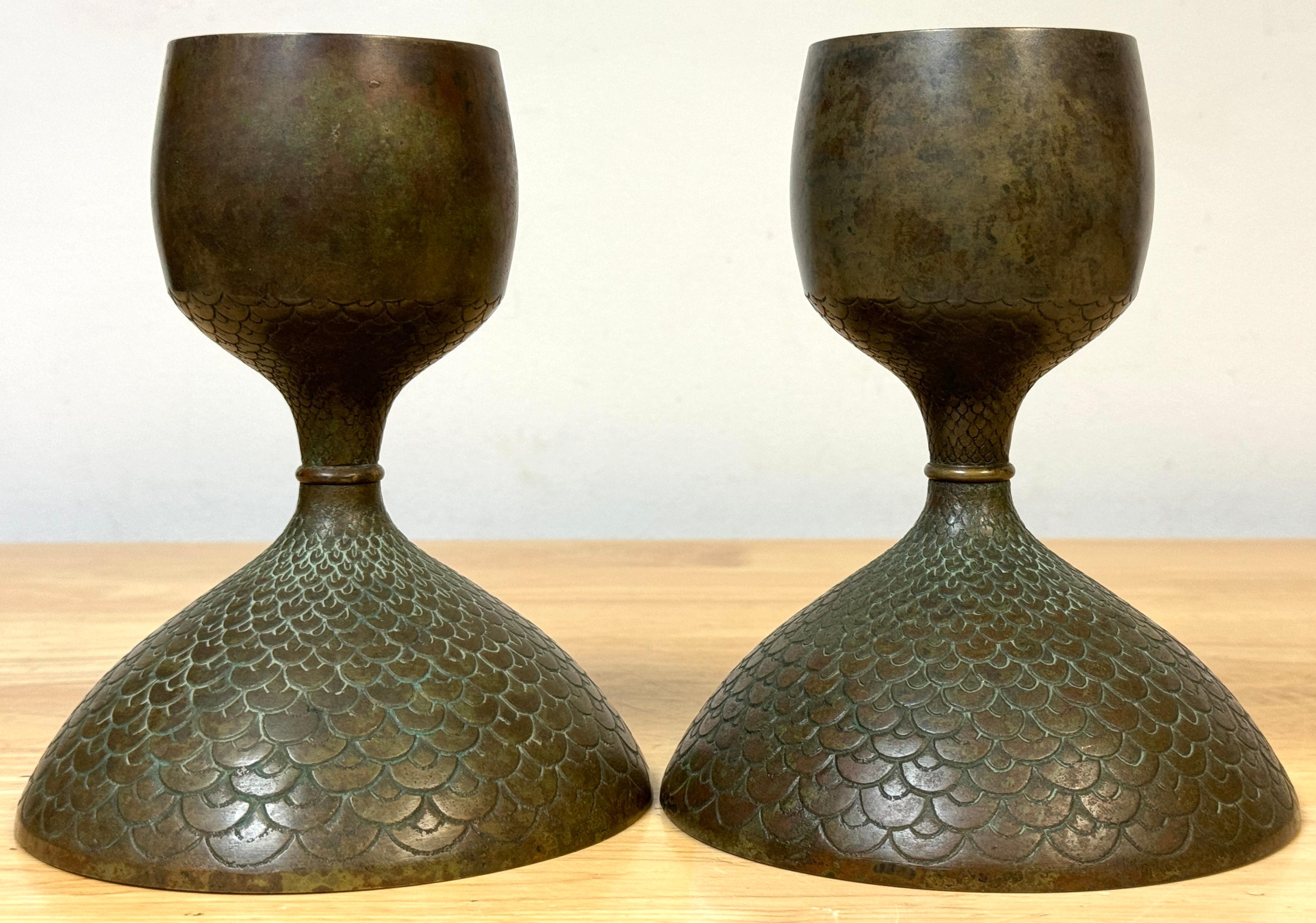 Pair Art Nouveau Bronze Fish Scale Candlesticks, Style of Tiffany Studios 
USA, 20th Century 

This exquisite pair of Art Nouveau Bronze Fish Scale Candlesticks, made in the style of Tiffany Studios, epitomizes the elegance and organic beauty of the