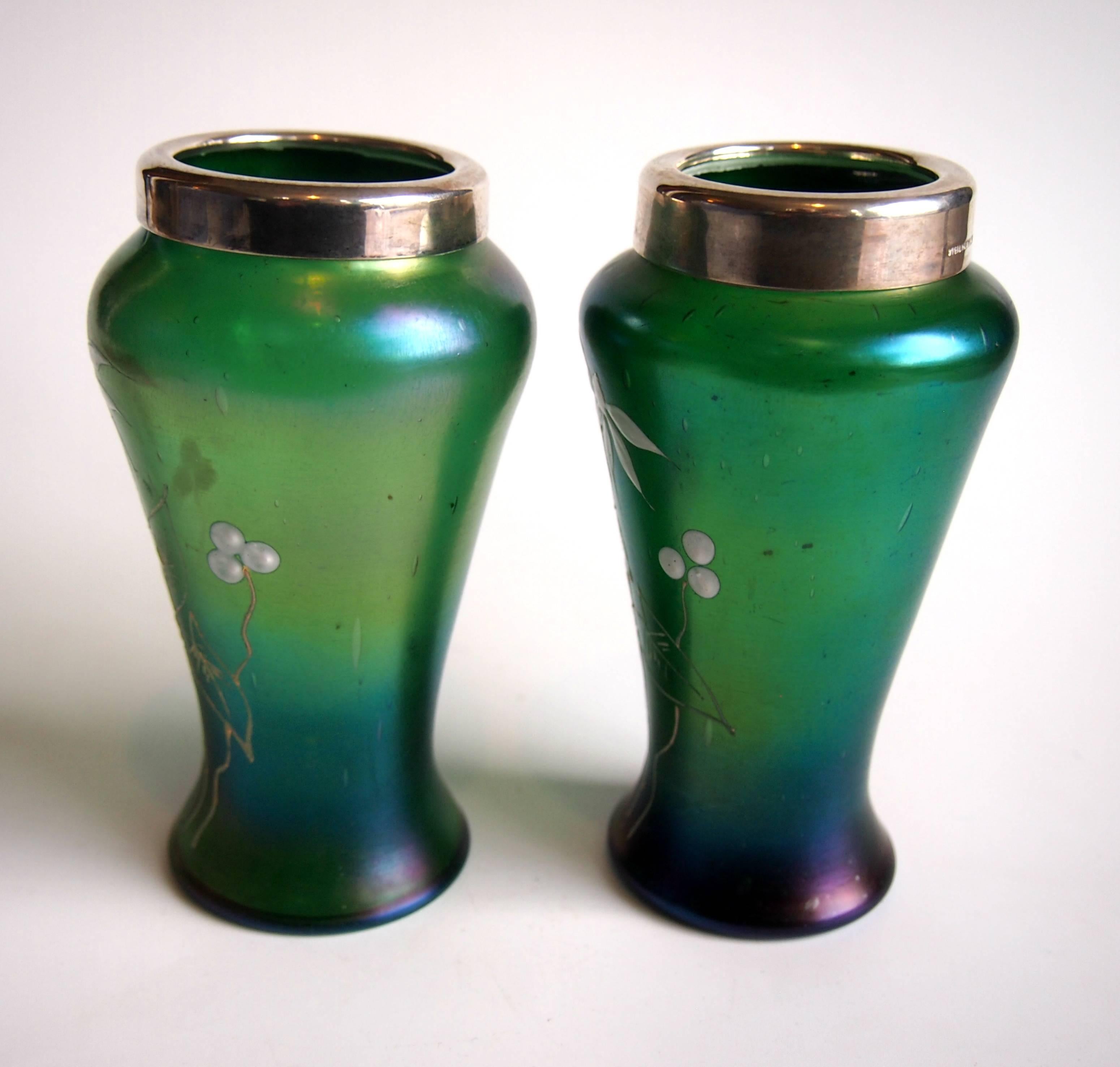 Fine pair of enamelled, iridised green Kralik vases with silver collars. The silver collars are marked sterling silver. The enamelling depicts snowdrops in bloom.

Kralik was at the time one of the largest Bohemian glass makers only a few miles