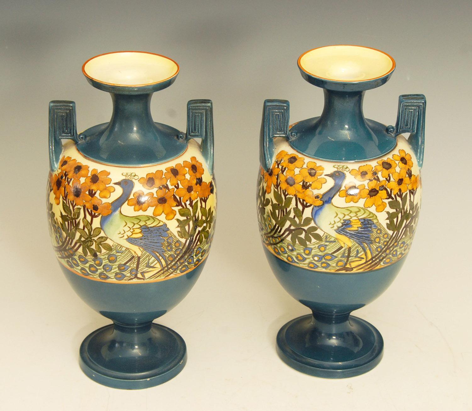 Pair of Art Nouveau Royal Staffordshire twin handled vases with hand painted peacocks.

Price includes shipping to anywhere in the world.