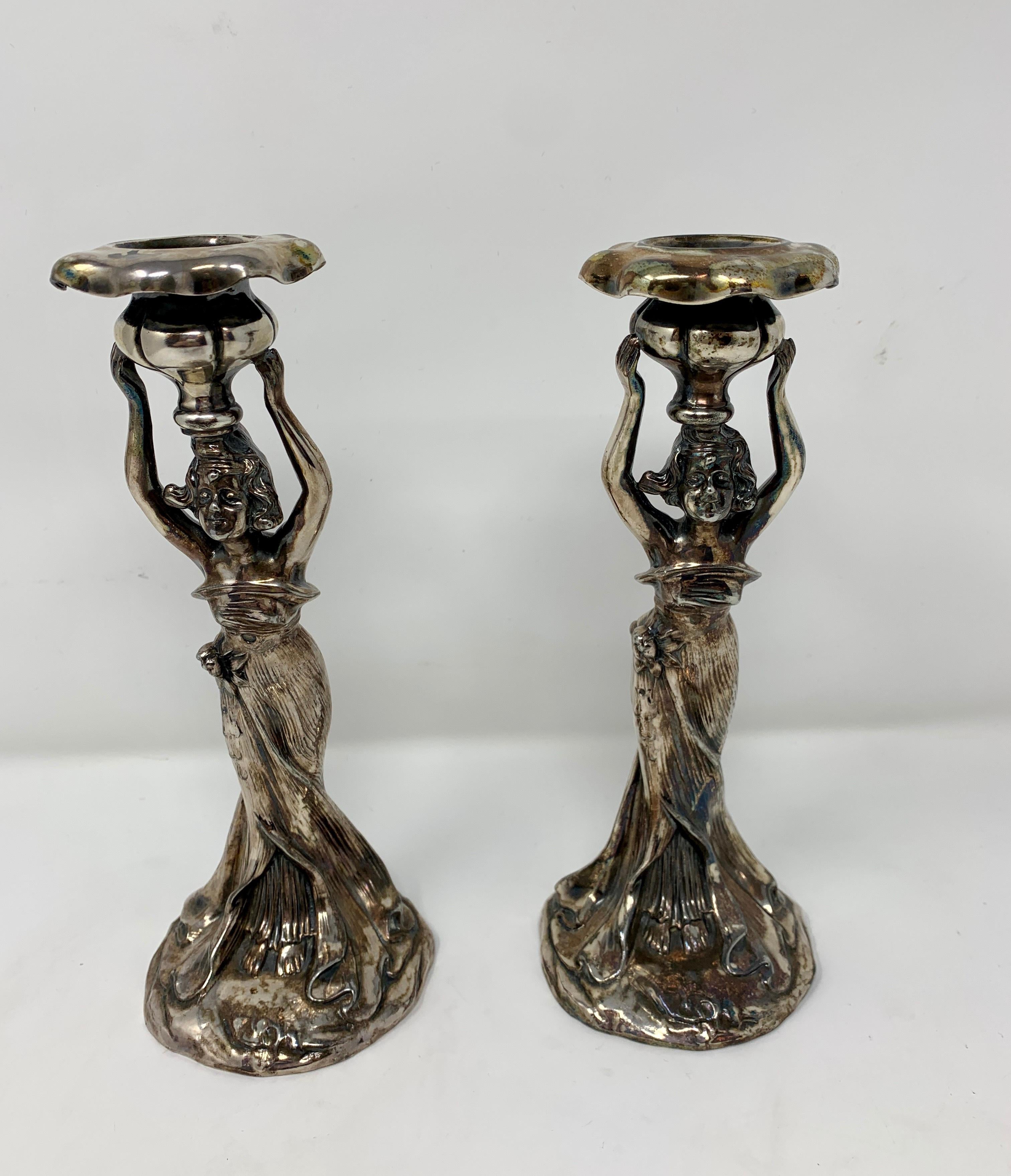 Figural candlesticks of young damsels.
   