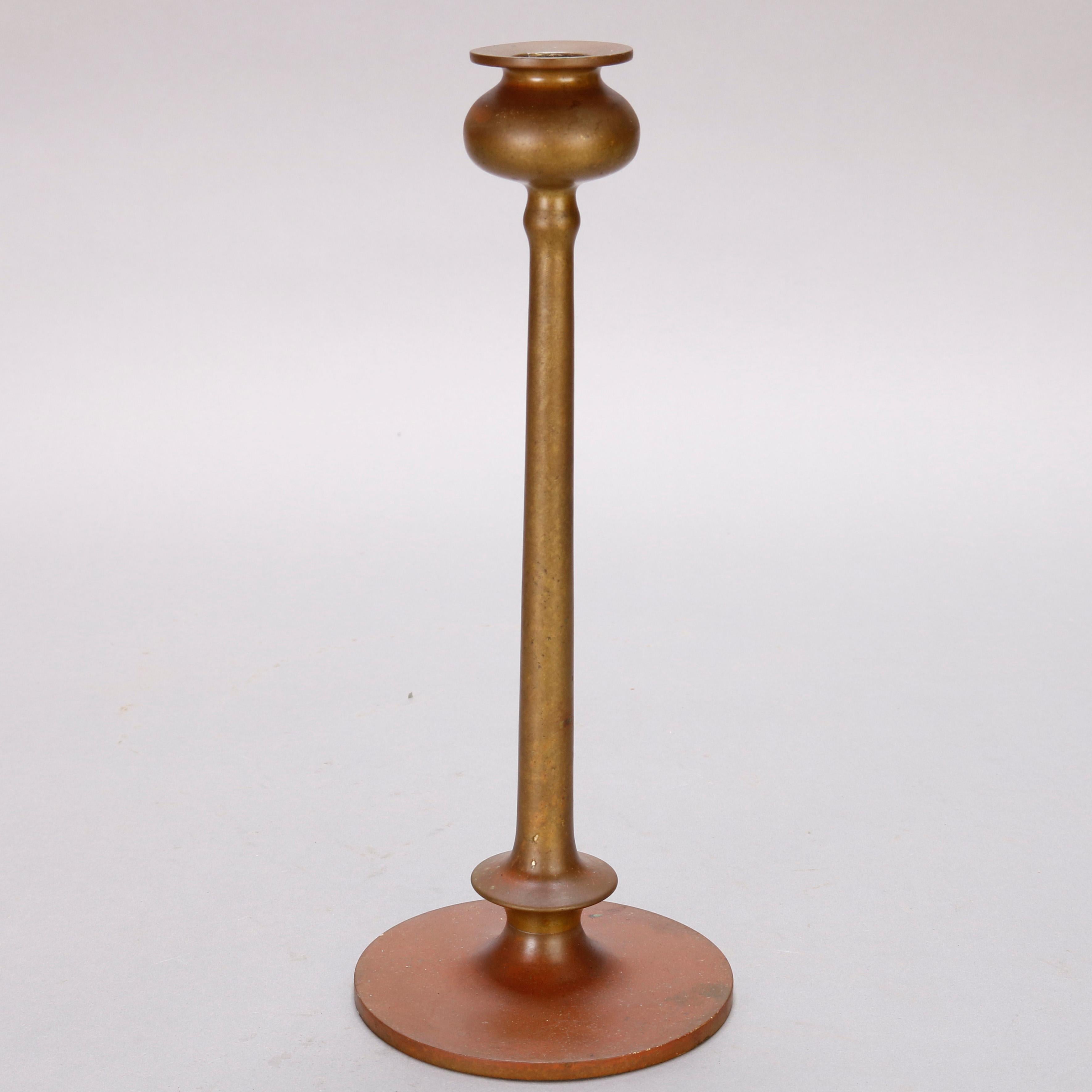 A pair of Arts & Crafts Jarvie School Mission style candle sticks offer Beta Form with swelled bulbous candle cup having flared bobeche surmounting slender columnar base flared to the foot and seated on a flat circular base, 20th