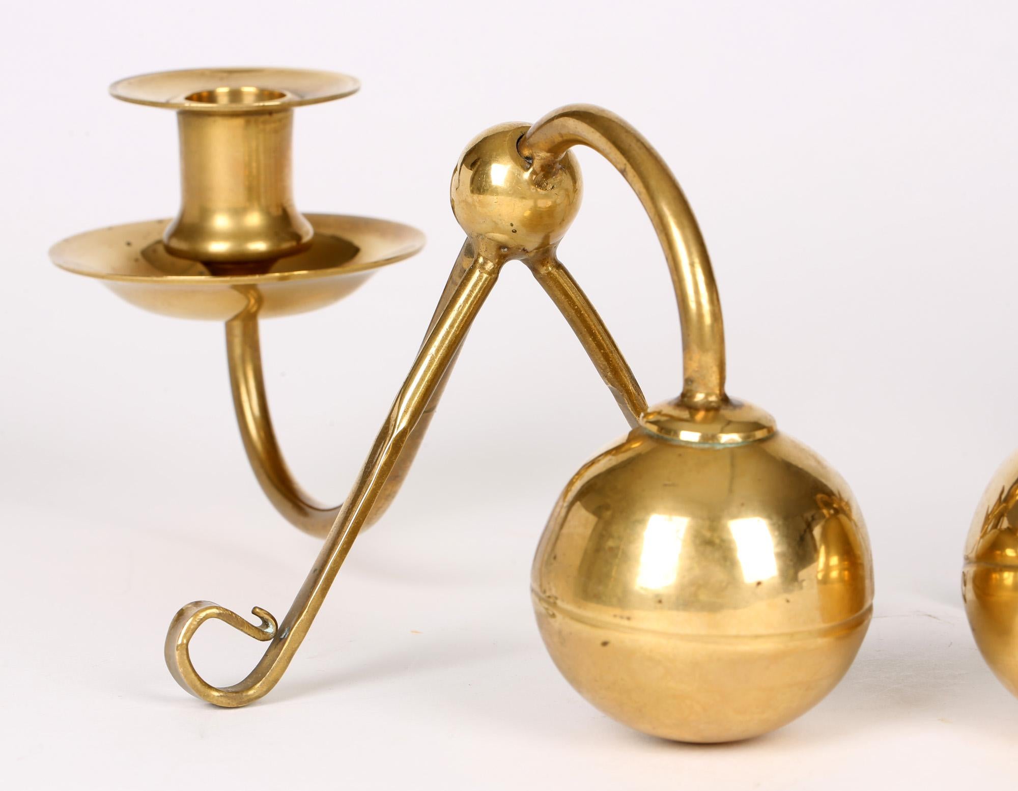 An unusual pair Arts & Crafts counter balanced brass candlesticks attributed to Benham & Froud and believed to have been made for use on an upright or grand piano dating from around 1890. The candlesticks are very reminiscent of a design by