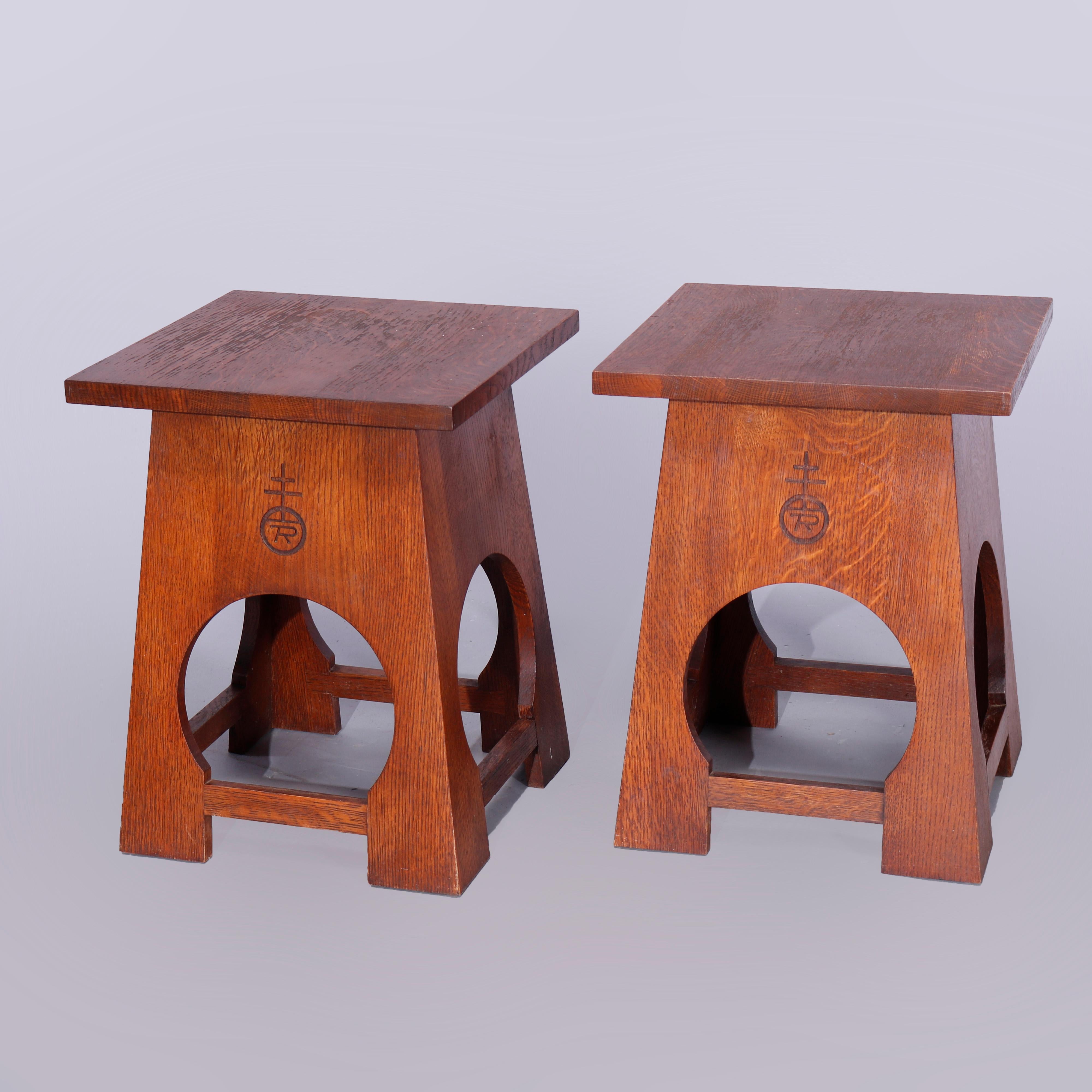 A pair of Roycroft Arts & Crafts Mission tabouret stands by Stickley offer oak construction with top surmounting flared bases with cutout legs, signed as photographed, 20th century

Measures: 20.25
