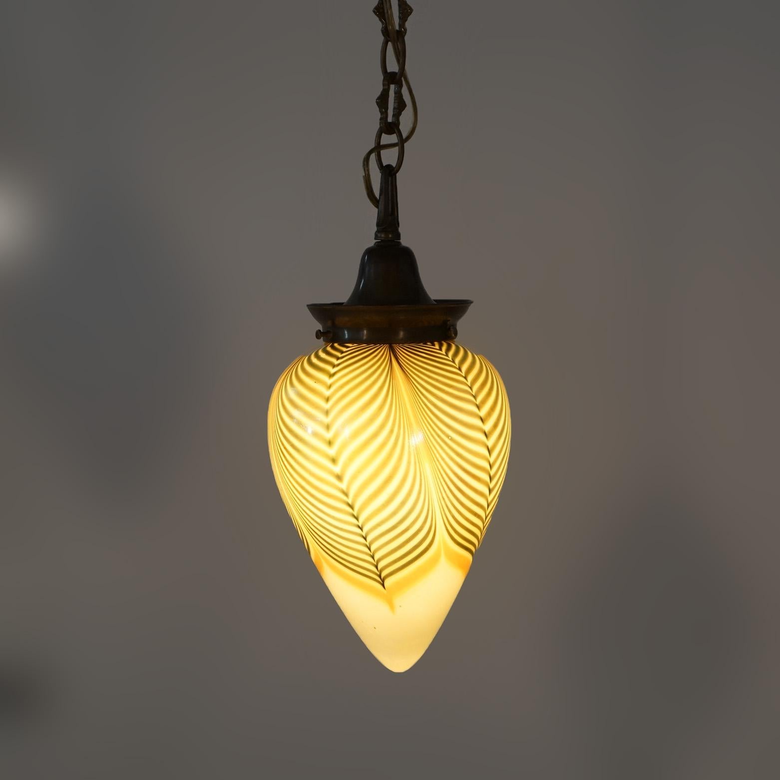 Pair of Arts & Crafts Pendant Lights with Steuben Pulled Feather Art Glass Egg Form Shades with Brass Frames, 20th century 

Measures- 44''H x 6''W x 6''D; 22''; fixture only 14