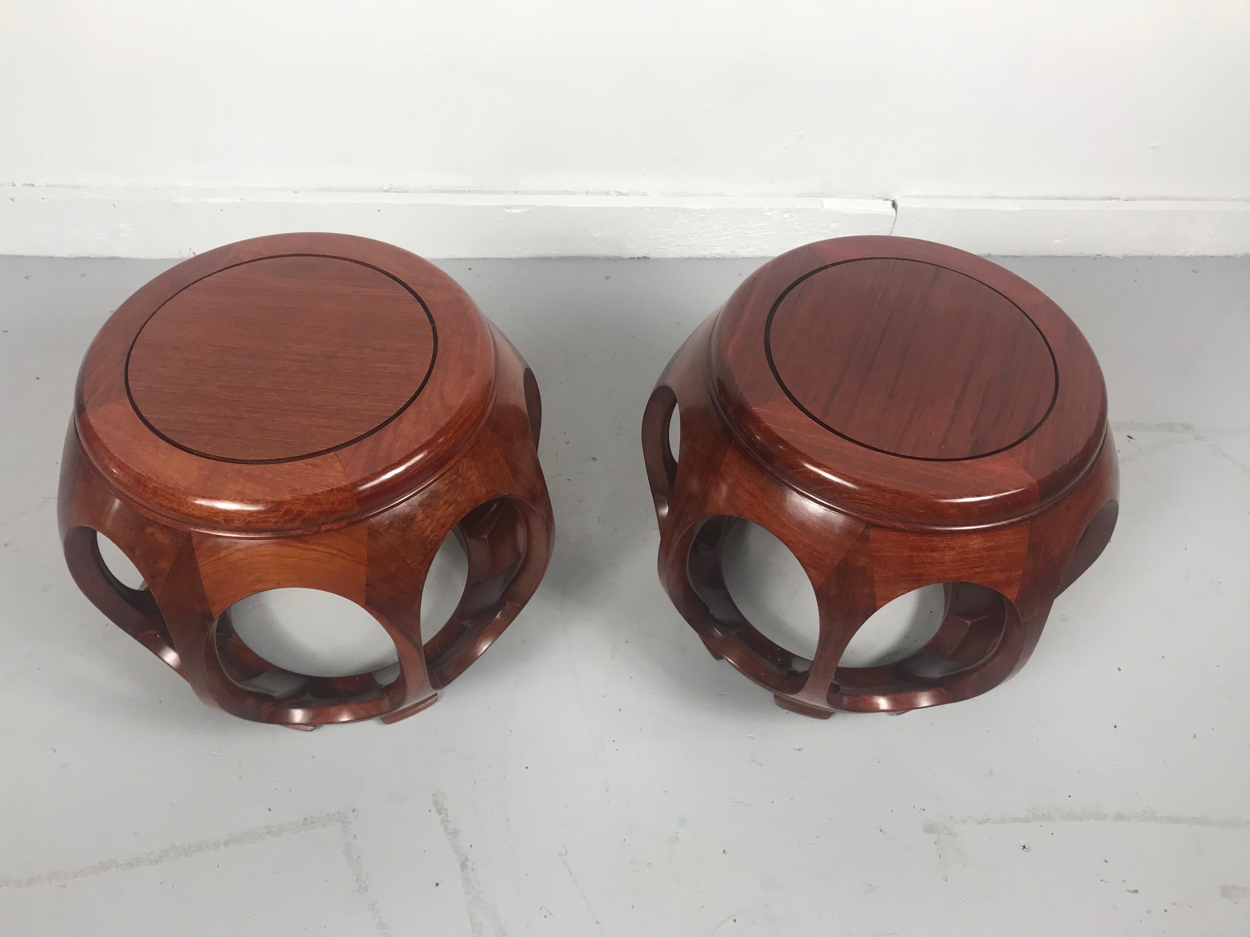 Pair of Asian rosewood garden stools mid-20th century, imported from Asia, sold through Baker Furniture. Beautifully crafted solid rosewood construction, dovetail joinery, Classic form, wonderful warm color and finish.