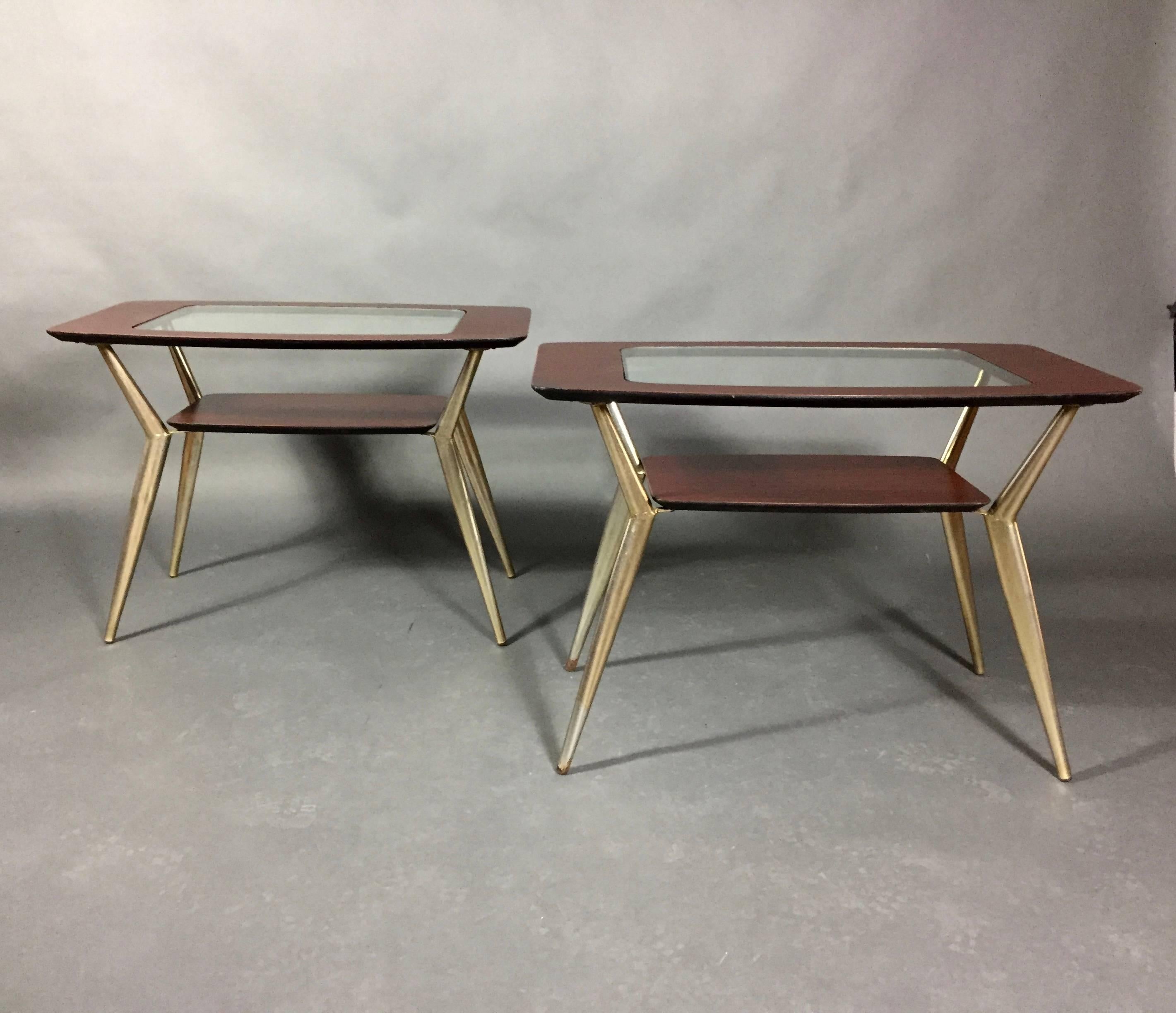 Perfect shape on this pair of Atomic metal and veneered end tables with insert glass top. The non-wood veneer has been refinished - some discoloration to metal legs remain - though we think this just adds to the charm. Designed with a bottom shelf